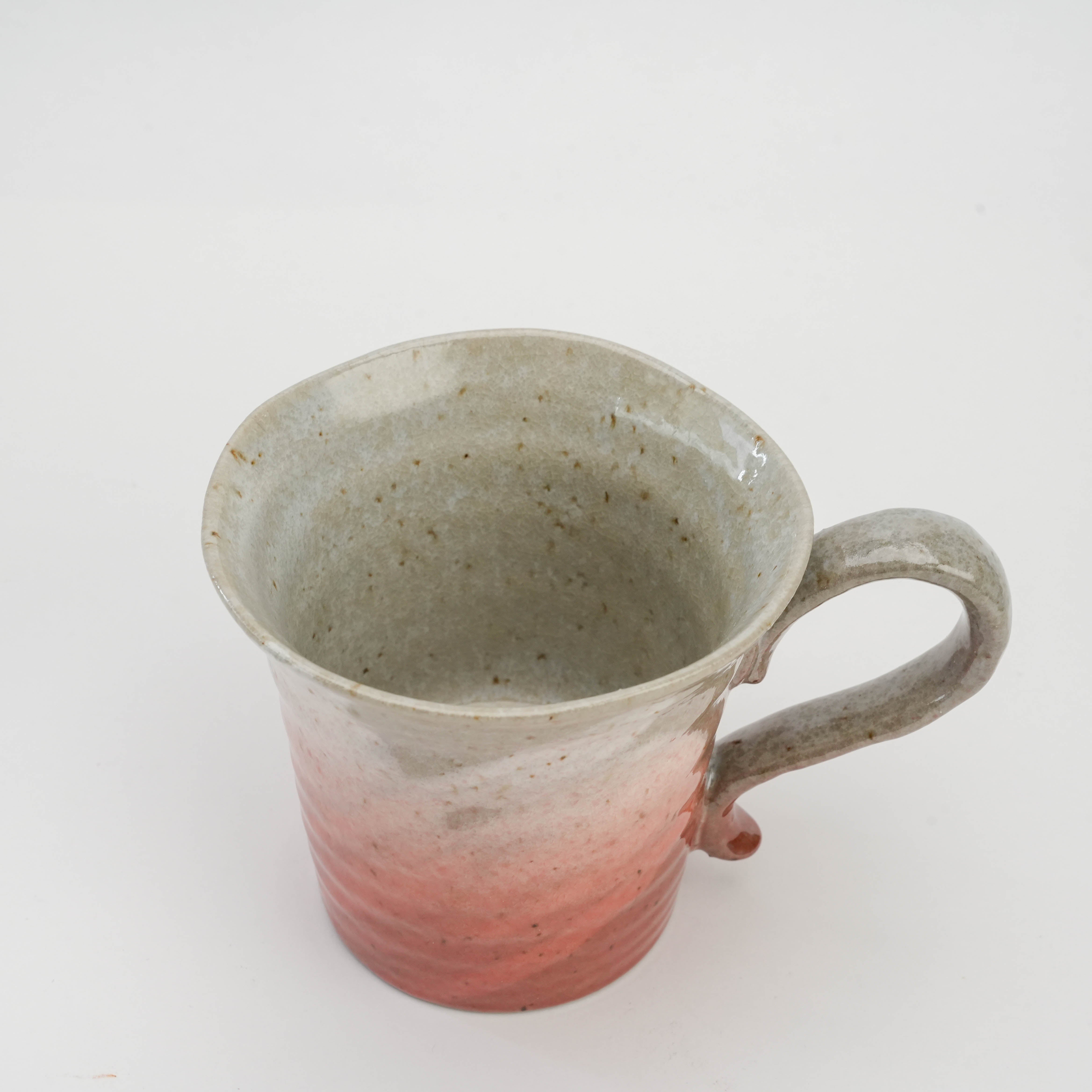 Top view of pink Kutani Ware Sakura Mug showing speckled ceramic interior and curved handle, ideal for stylish tea or coffee moments.