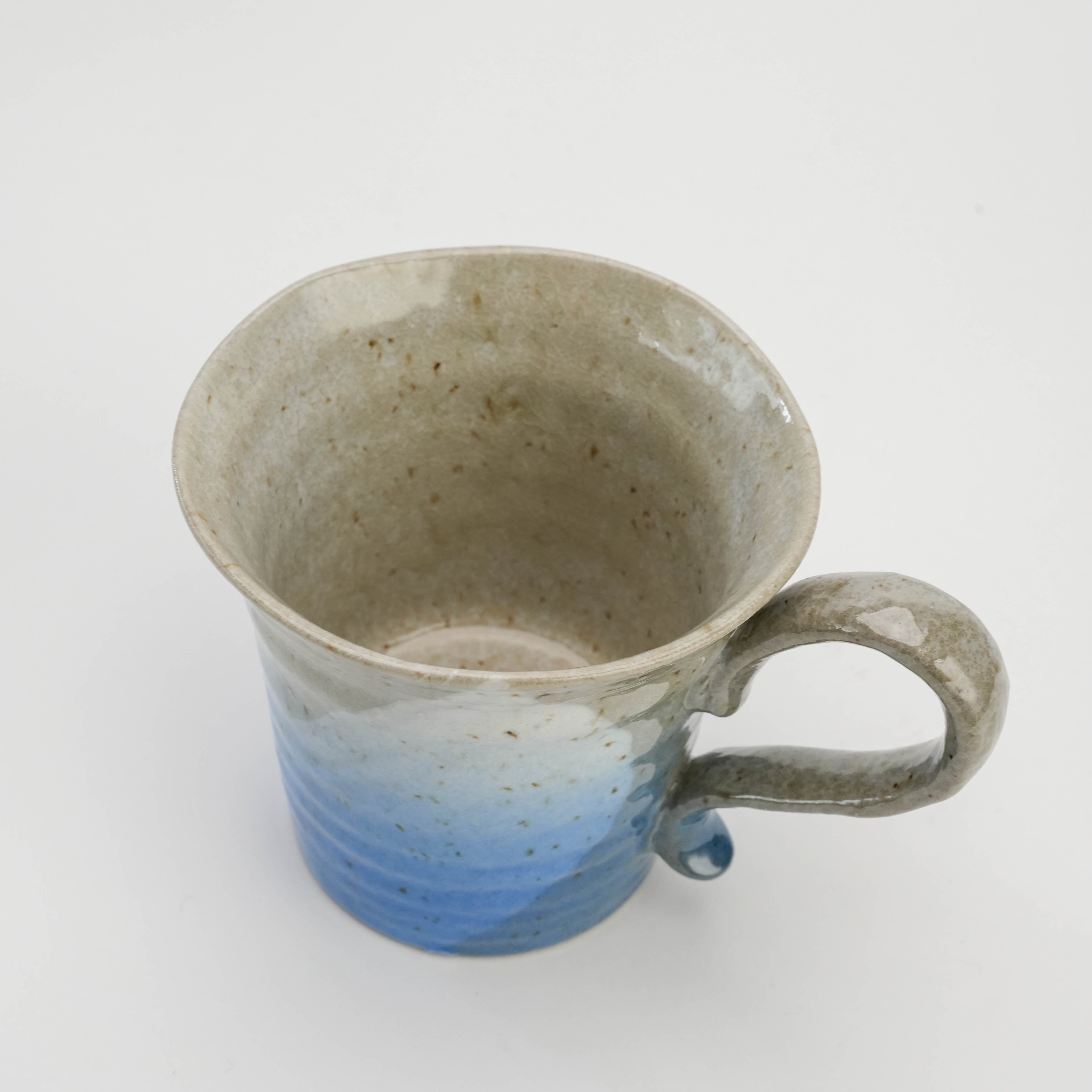 Top view of ocean blue Kutani Ware Sakura Mug revealing speckled interior and ergonomic handle, ideal for daily use or gifting.