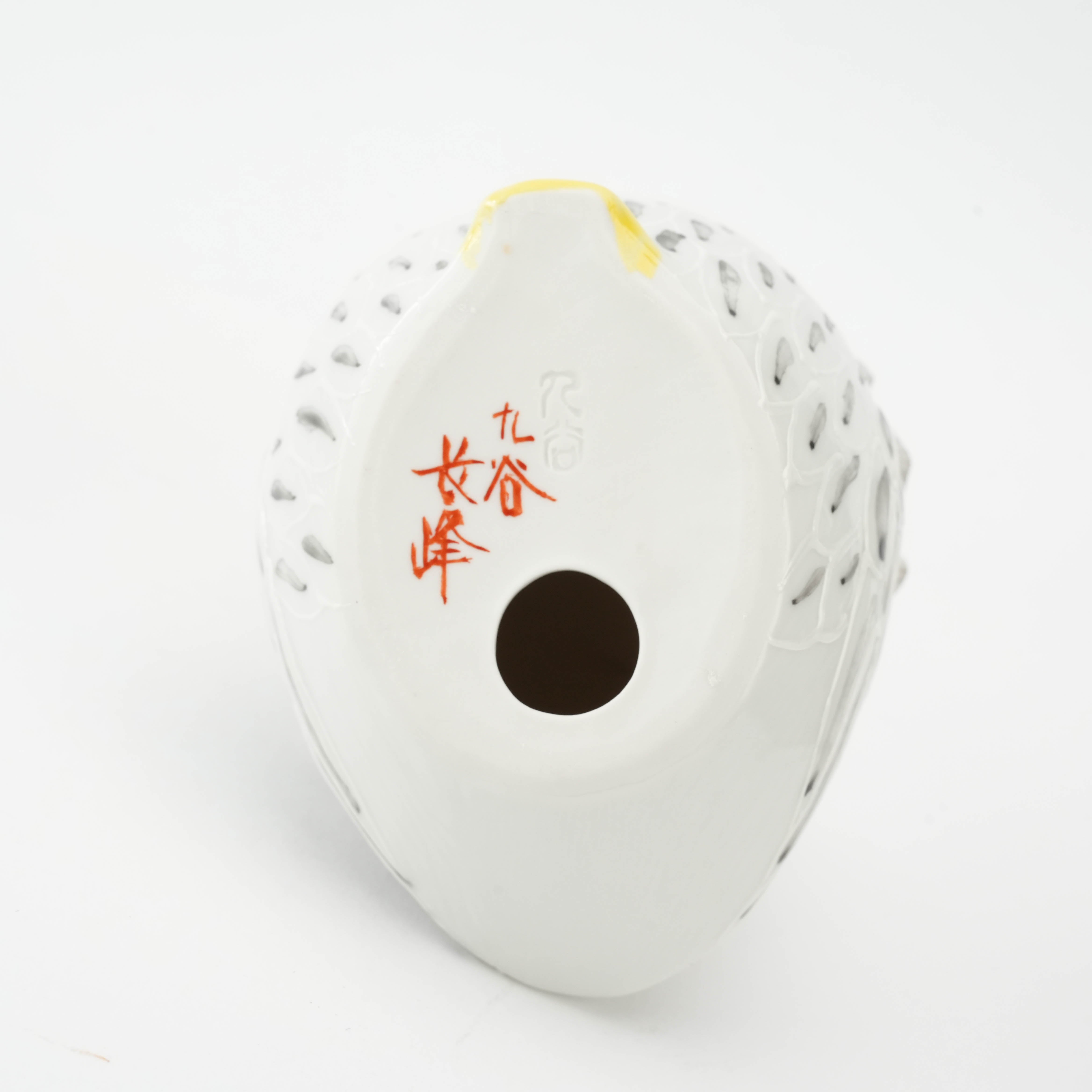 Bottom of Kutani Owl Figurine showing signature red Kutani mark and hollow base. Authentic Japanese craftsmanship in ceramic decor.