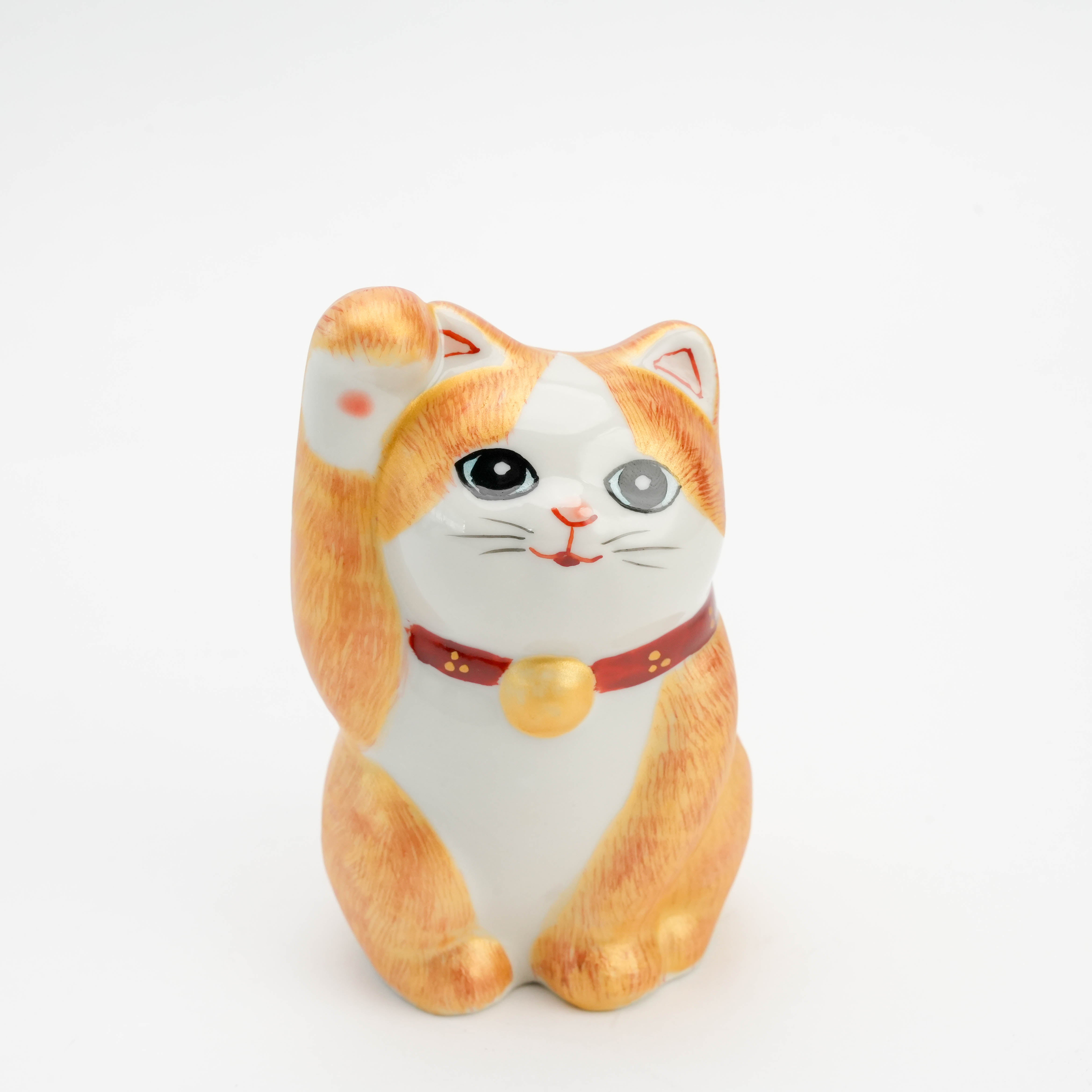 Front close-up of Kutani Ware Cat Ornament with expressive eyes, gold bell, and hand-painted fur. A charming figurine symbolizing luck and happiness.