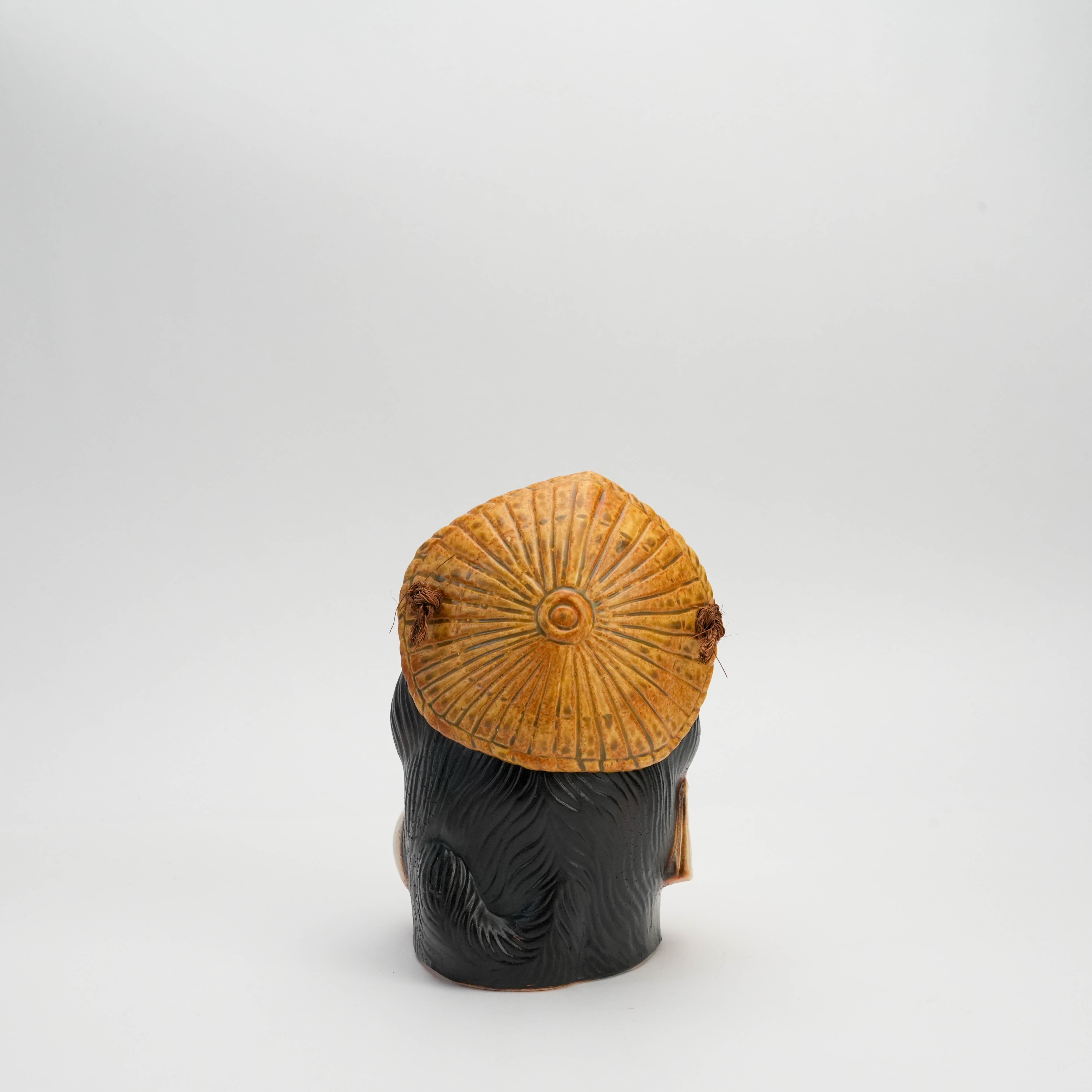 Back view of Shigaraki Ware Female Tanuki Ornament highlighting the textured straw hat and black fur detailing. Decorative raccoon dog figurine.