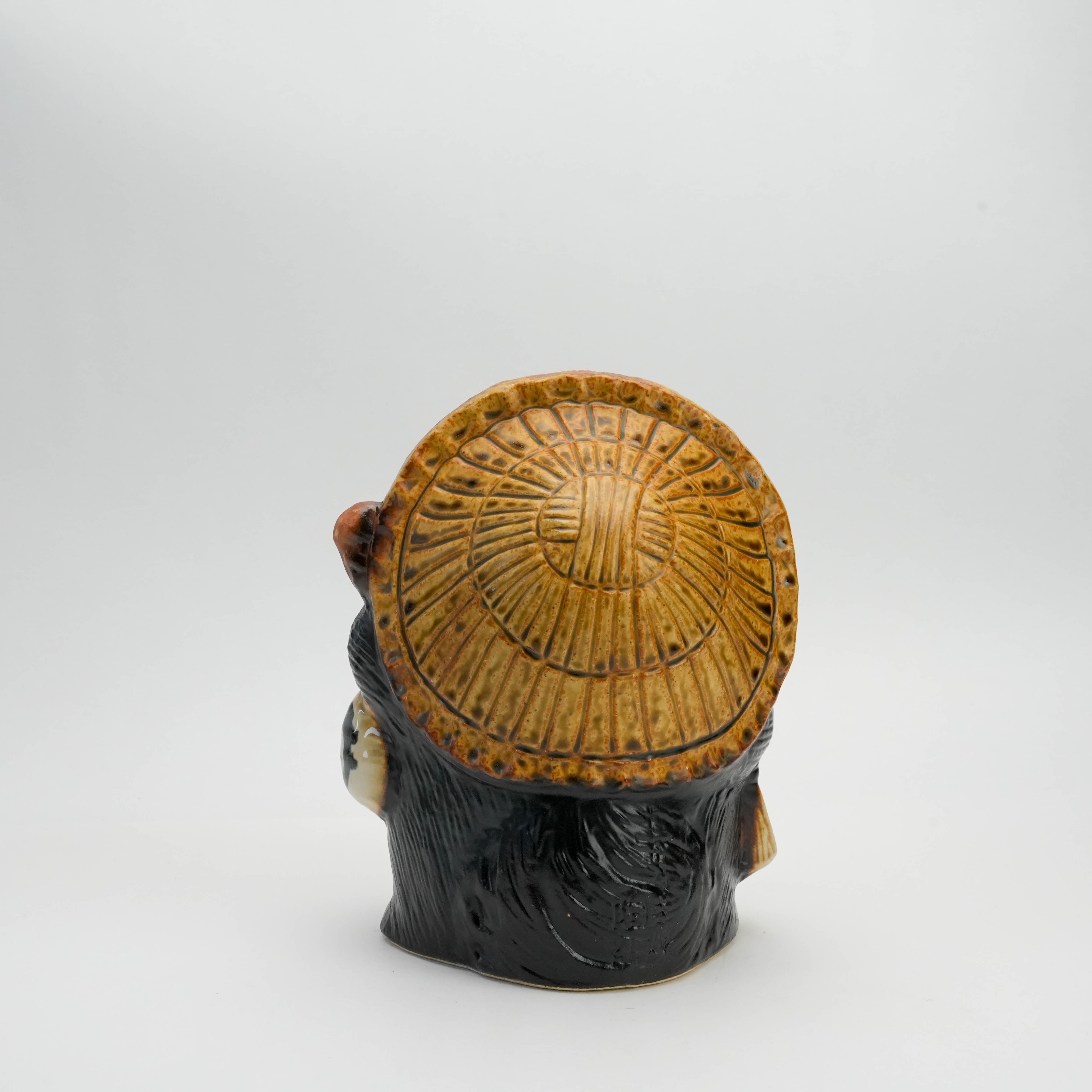 Rear view of Fukufuku Tanuki Raccoon Ornament highlighting the textured straw hat in traditional Shigaraki ceramic style.