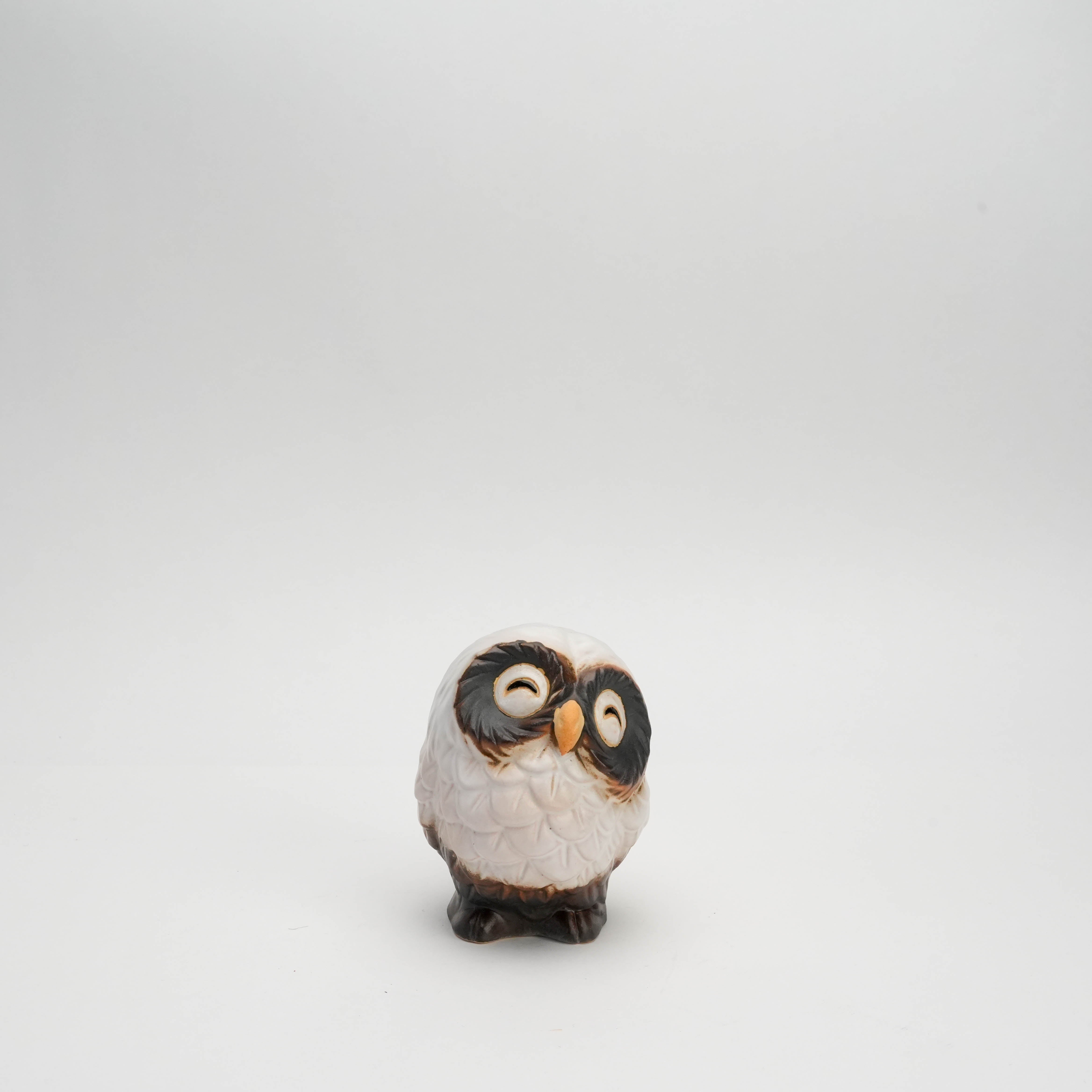 Front view of small handcrafted Shigaraki Ware white smiling owl ornament, ideal for festive home accents or thoughtful gifts.