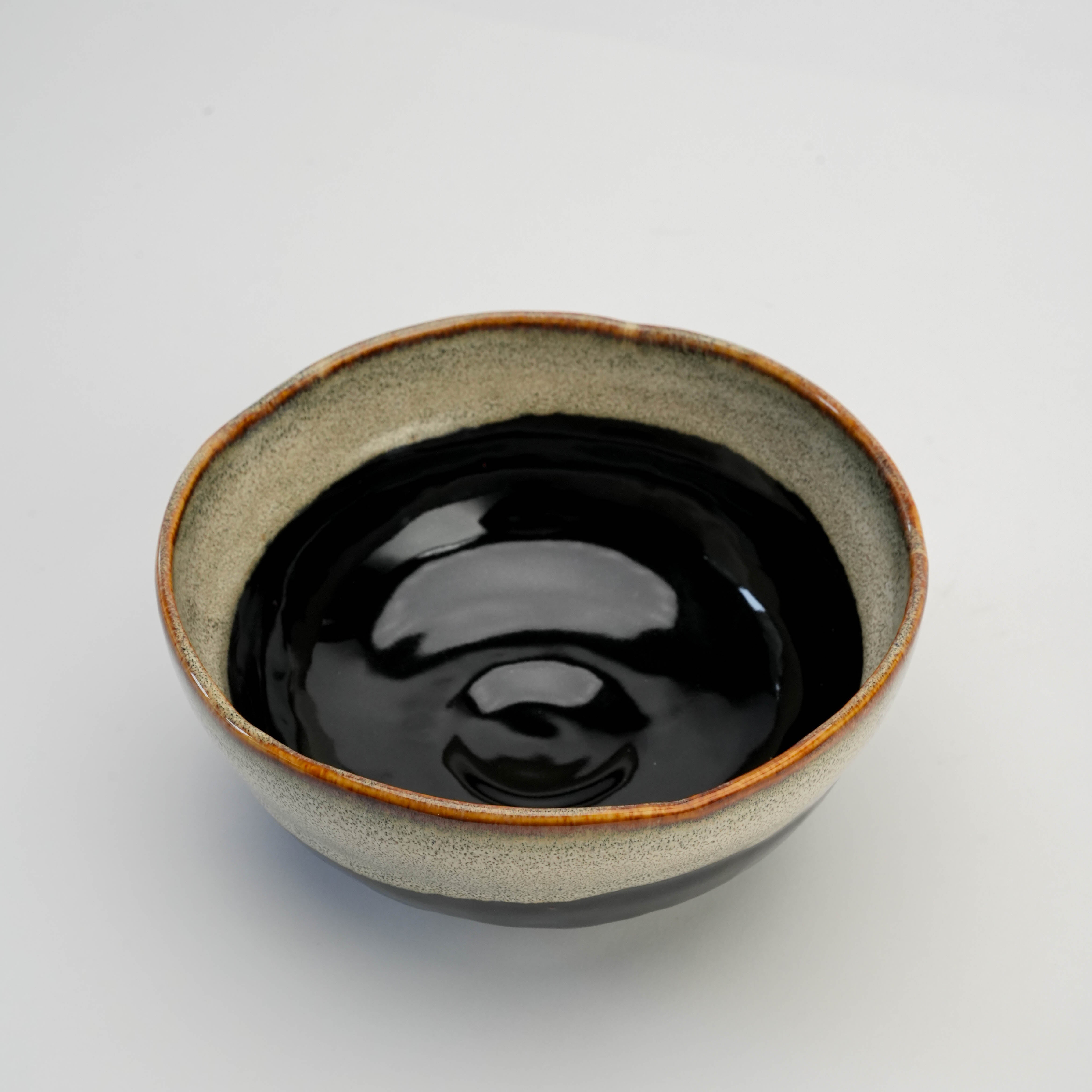 Top view of Mino Ware Unofu Tenmoku Japanese Bowl with deep black interior and handcrafted two-tone ceramic design.