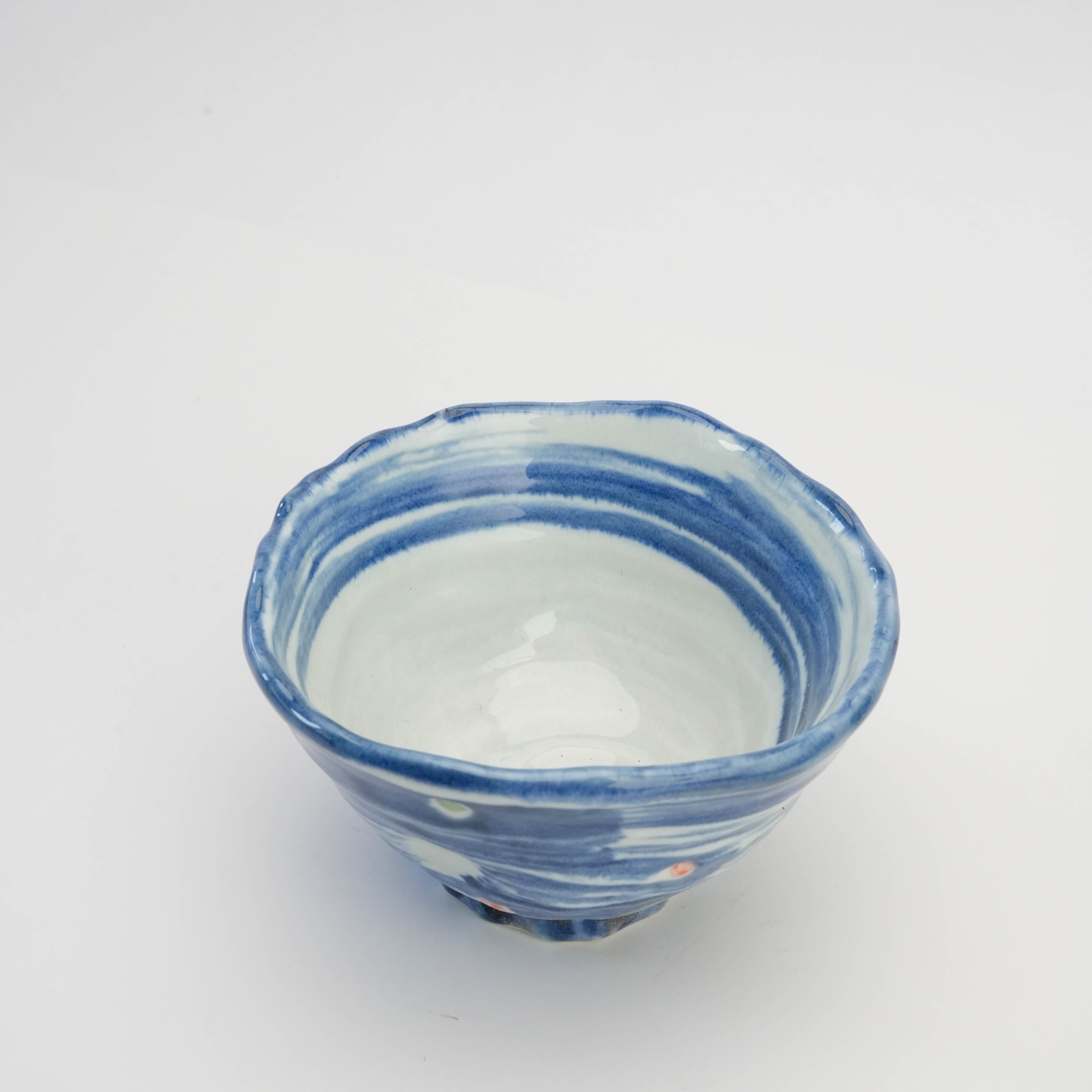 Top view of Mino Ware Hakeme Polka Dot Tri-Pressed Donburi Bowl showcasing its unique scalloped rim and artisan glaze pattern.