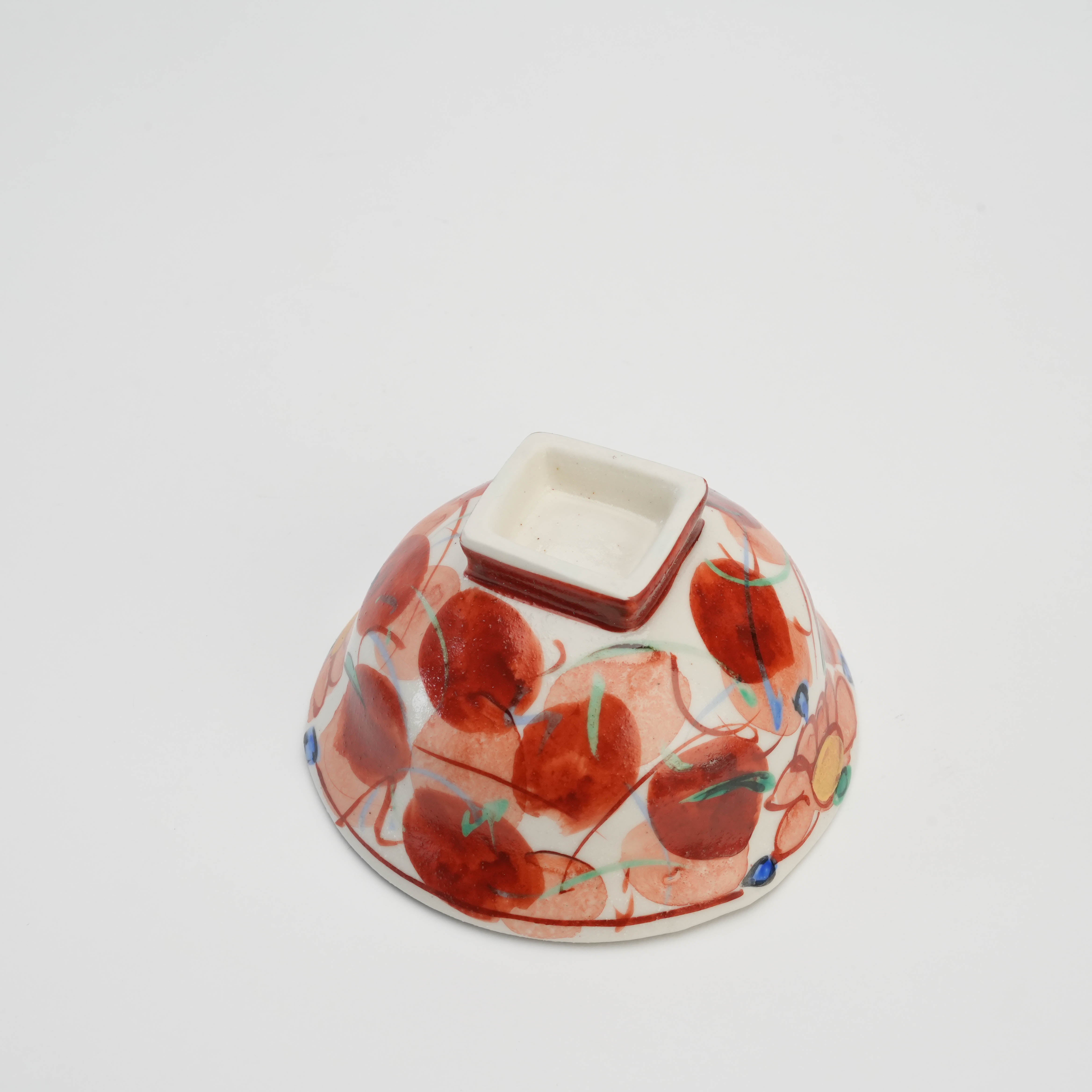 Bottom view of Mino Ware Akae Konoha Rice Bowl revealing square base and vivid red leaf patterns, blending tradition with functional design.