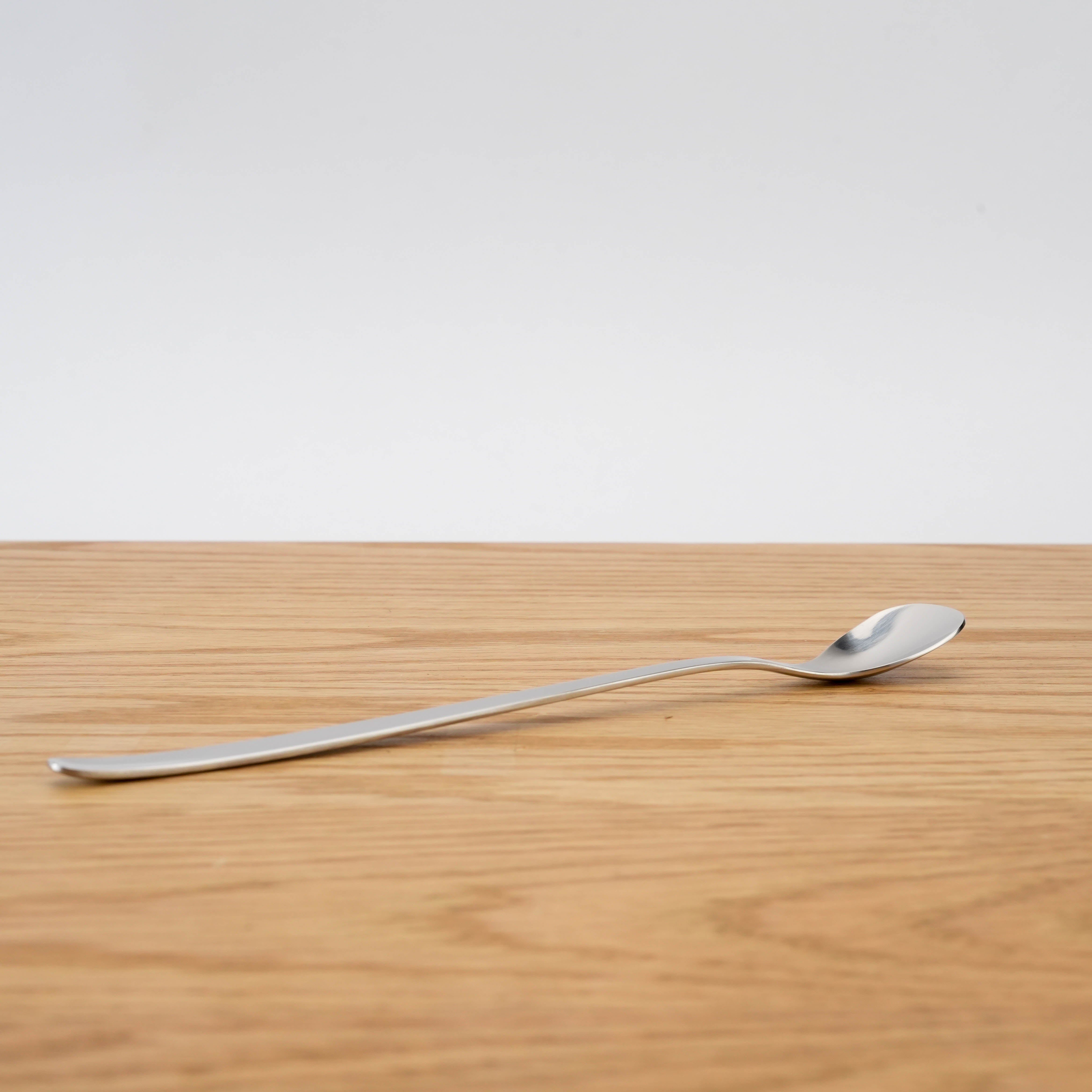 Side profile of Sori Yanagi Parfait Spoon - Stainless Steel | Japan, 185mm, emphasizing its elegant curvature and long handle.