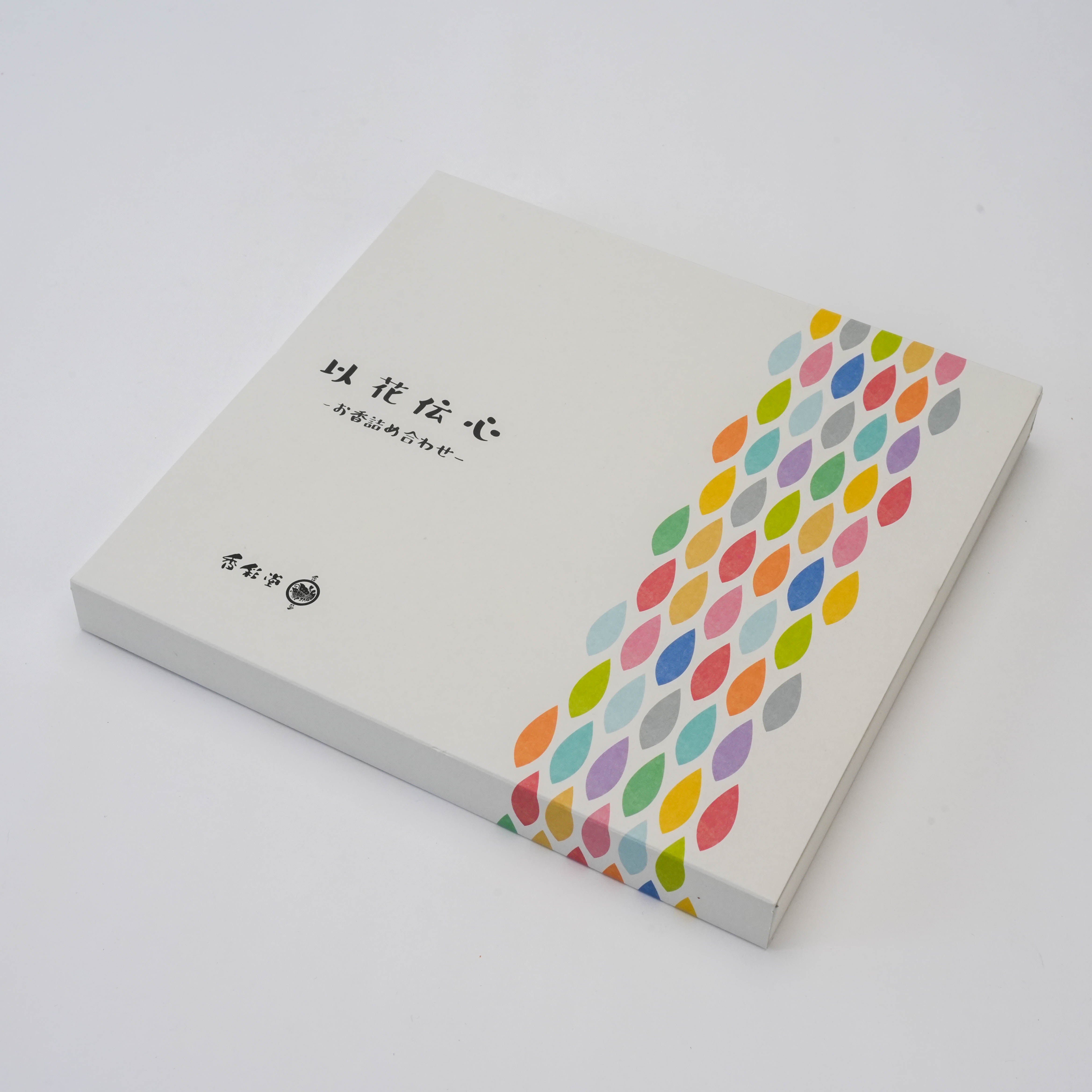 Closed Ihana-Denshin Gift Box - 12 Incense Sticks with minimalist white design and multicolored leaf pattern, ideal for gifting.