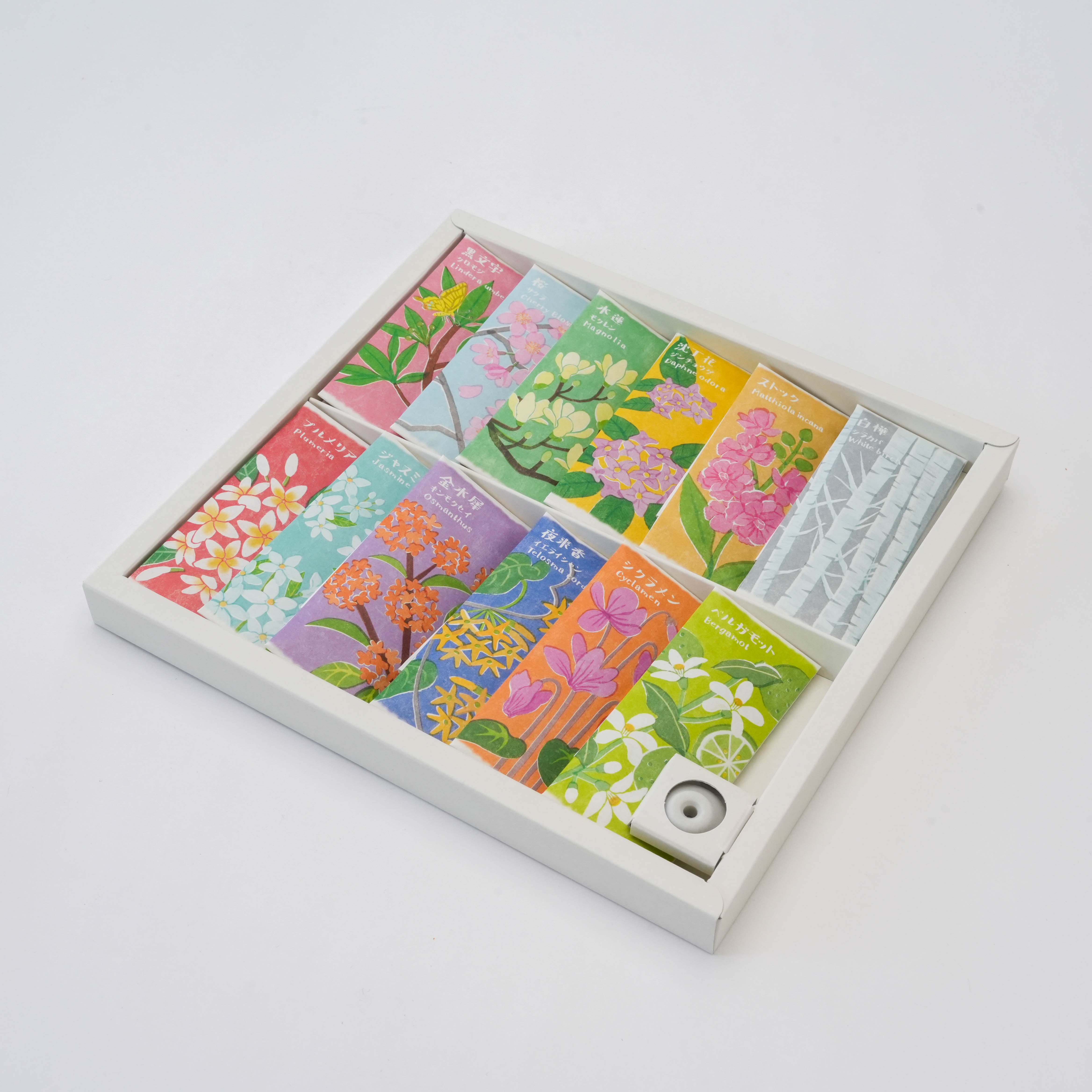 Ihana-Denshin Gift Box - 12 Incense Sticks | 12 Fragrances featuring colorful floral packaging and included incense stand in white tray.