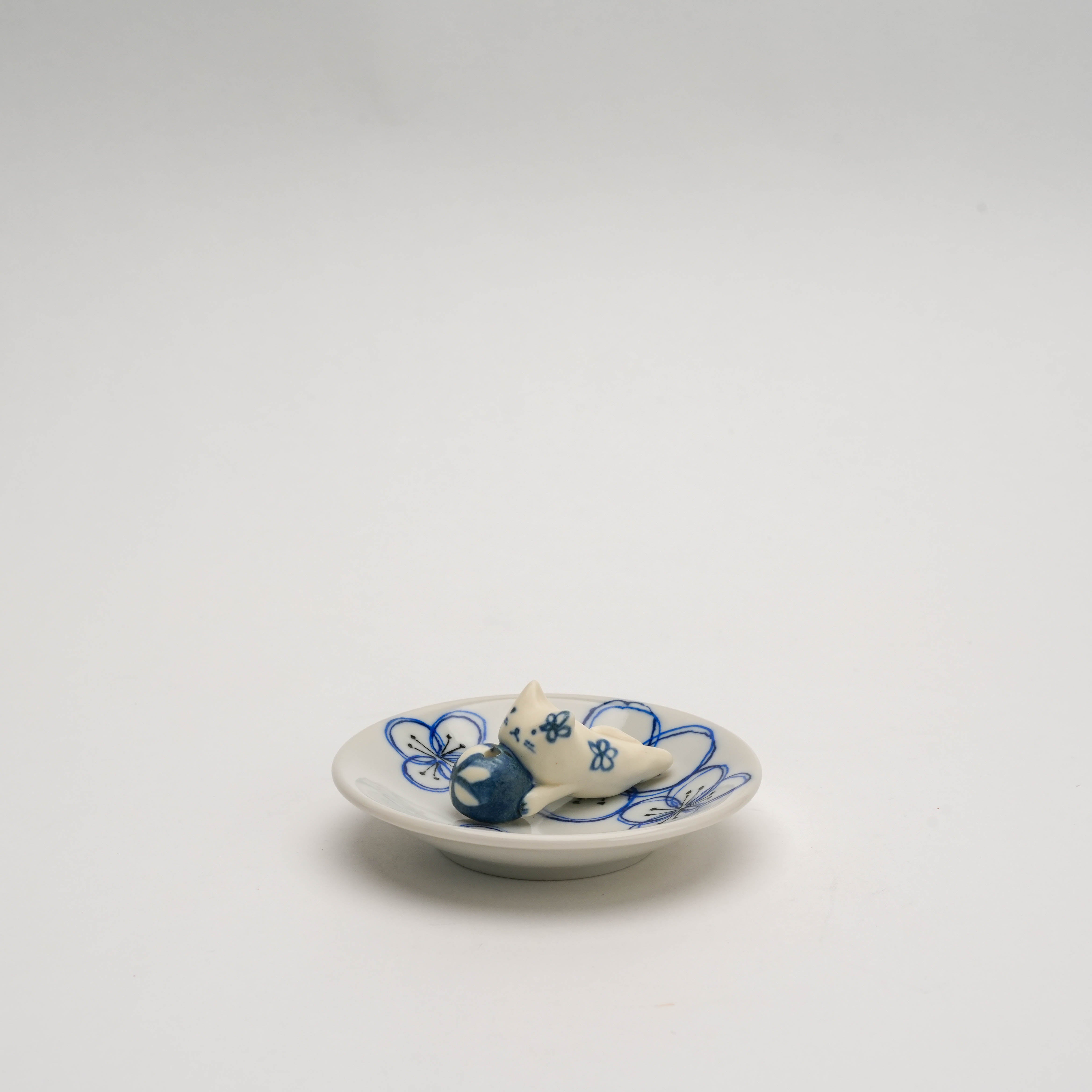 Minimalist display of Dyed Flower Cat Incense Holder with ceramic cat and blue floral accents, ideal for home fragrance decor.