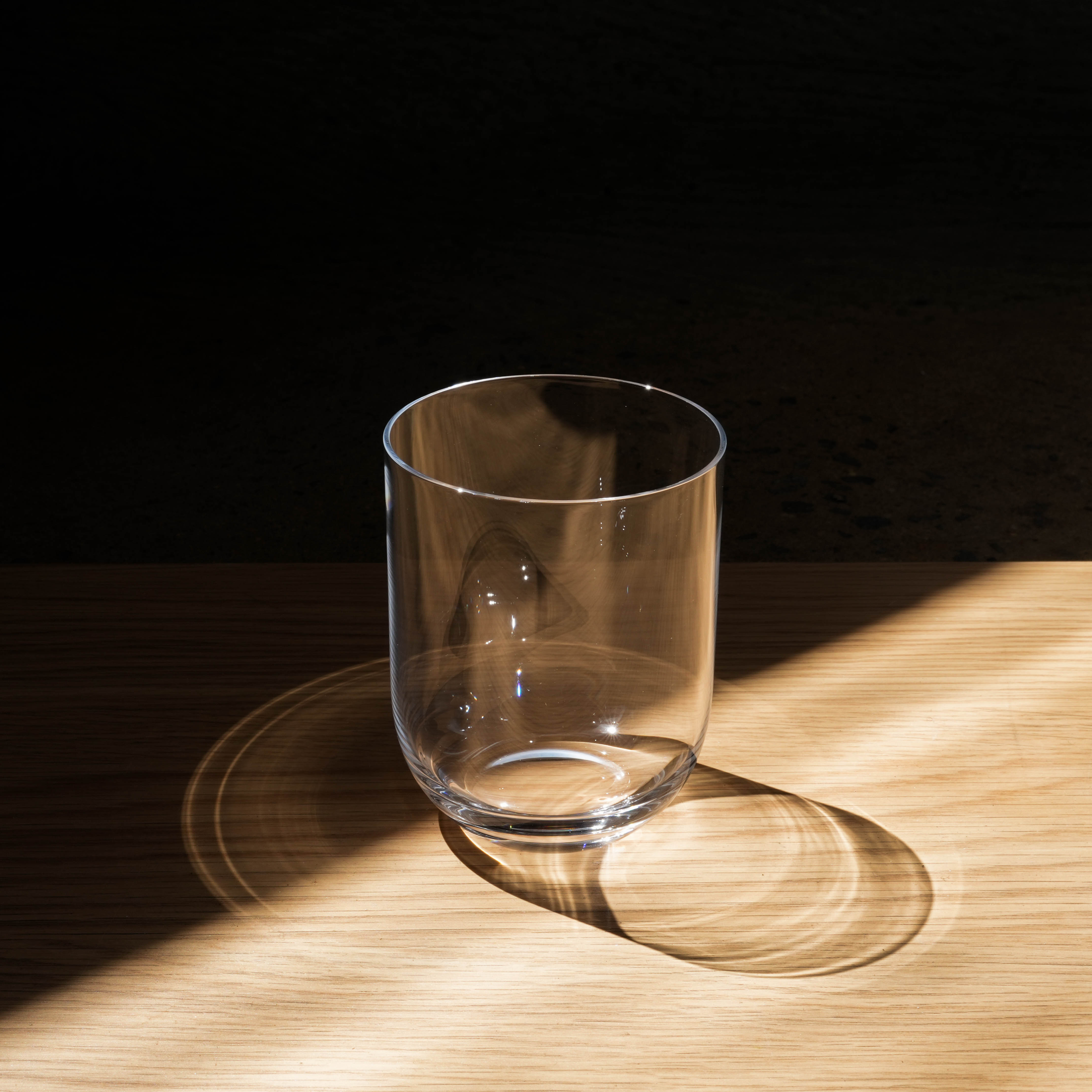 Close-up of Toyo-Sasaki handcrafted glass cup from the Night Carafe set, showcasing its minimalist design and clarity.