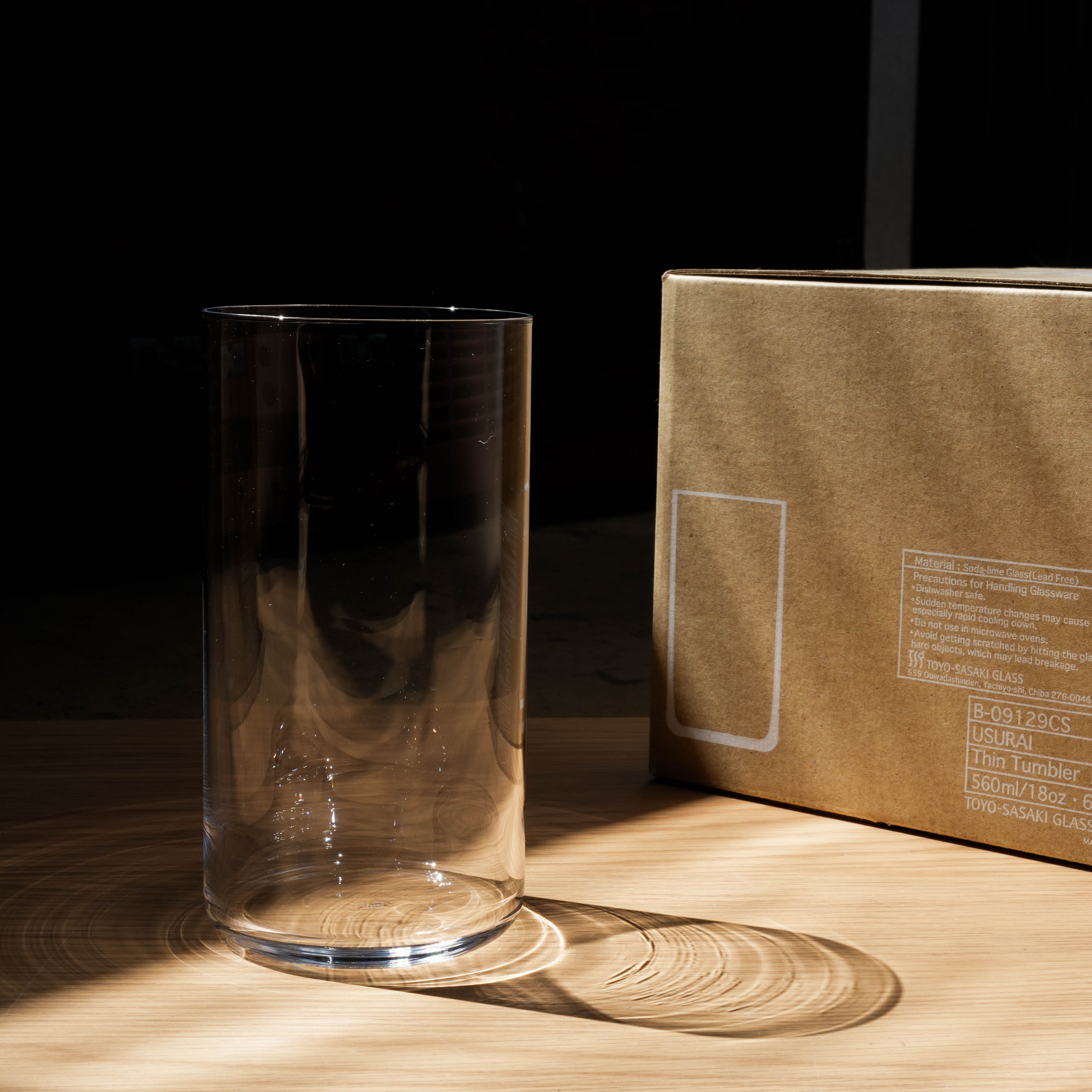 Toyo-Sasaki HS Usurai Tall Tumbler beside its packaging box, highlighting its durable, scratch-resistant glass ideal for modern kitchens.