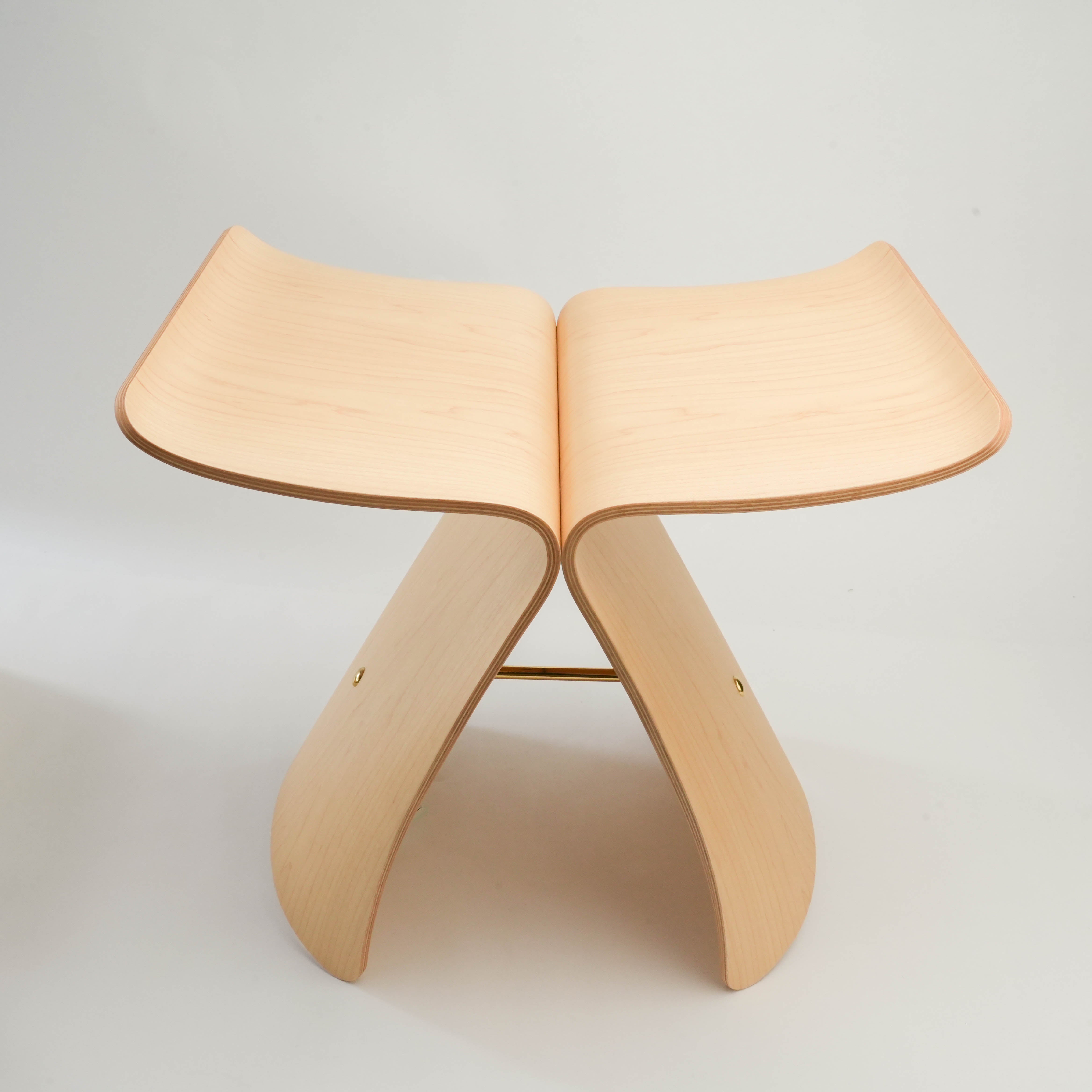 Front view of Butterfly Stool by Sori Yanagi in light wood, highlighting its symmetrical molded plywood wings and minimalist form.