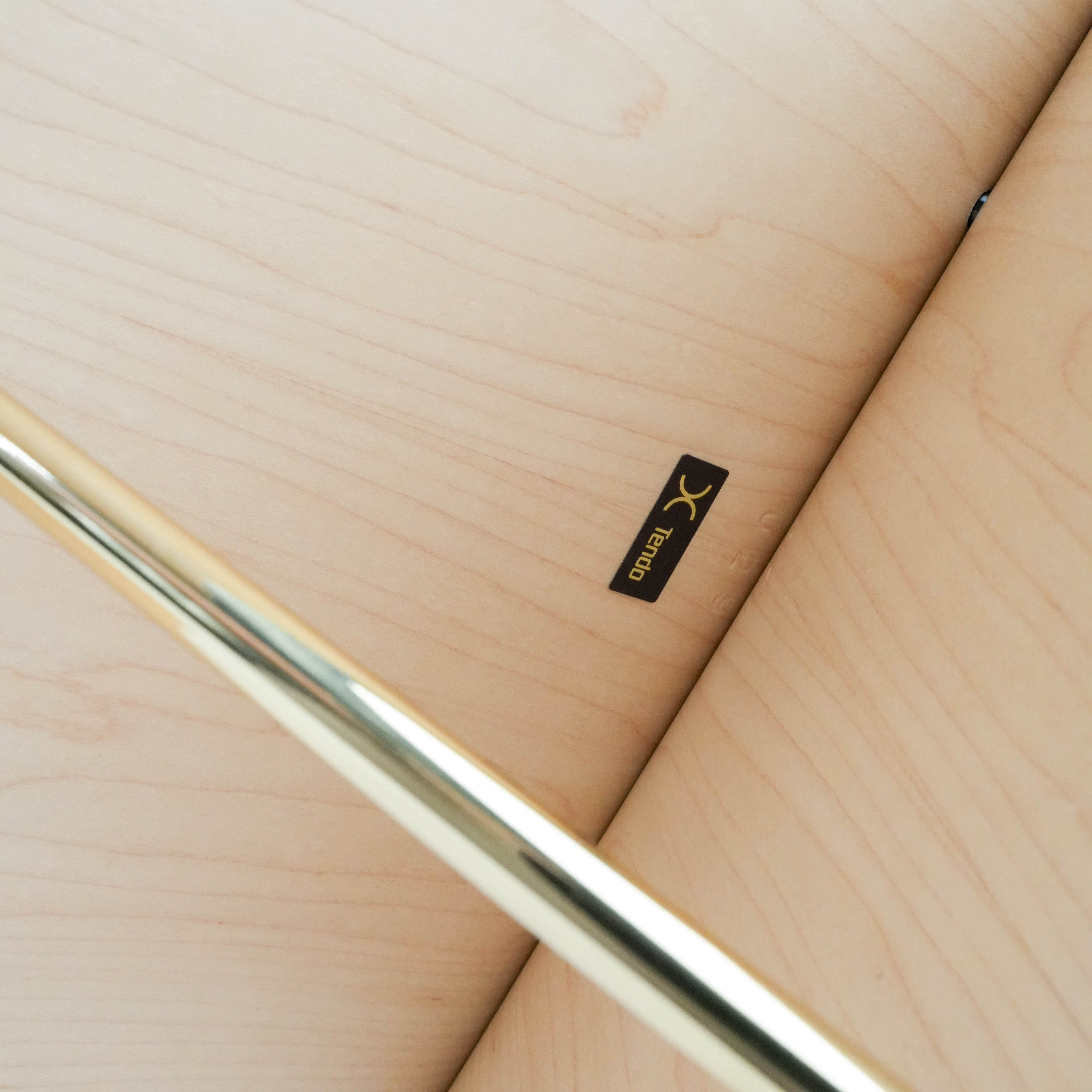 Detail of Tendo Mokko logo on the inner surface of the Butterfly Stool, showcasing authentic Japanese craftsmanship.
