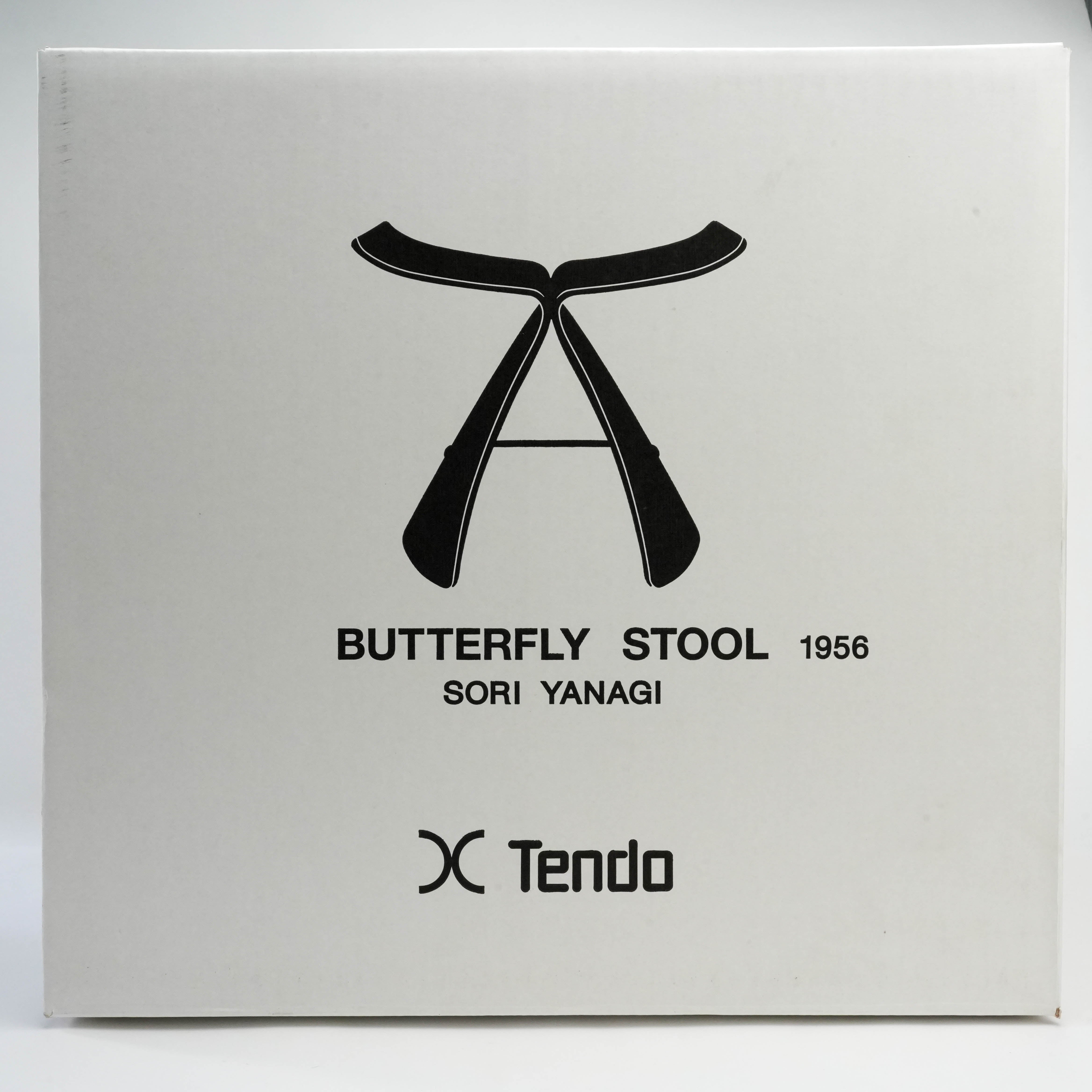 Packaging box for Butterfly Stool by Sori Yanagi, featuring minimalist black illustration and Tendo branding from 1956.