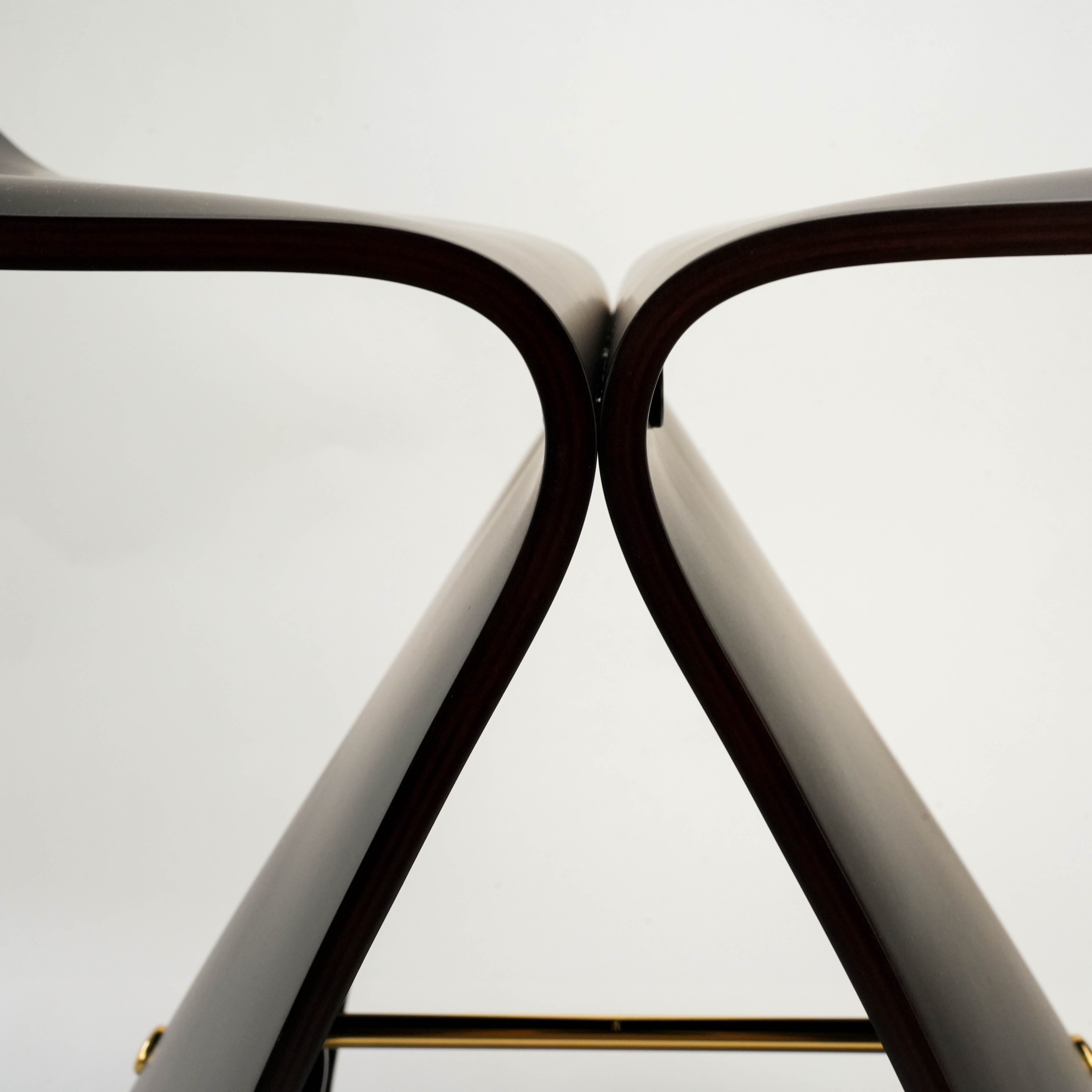 Top view of dark wood Butterfly Stool, focusing on the elegant curvature and precision joinery of the molded plywood.
