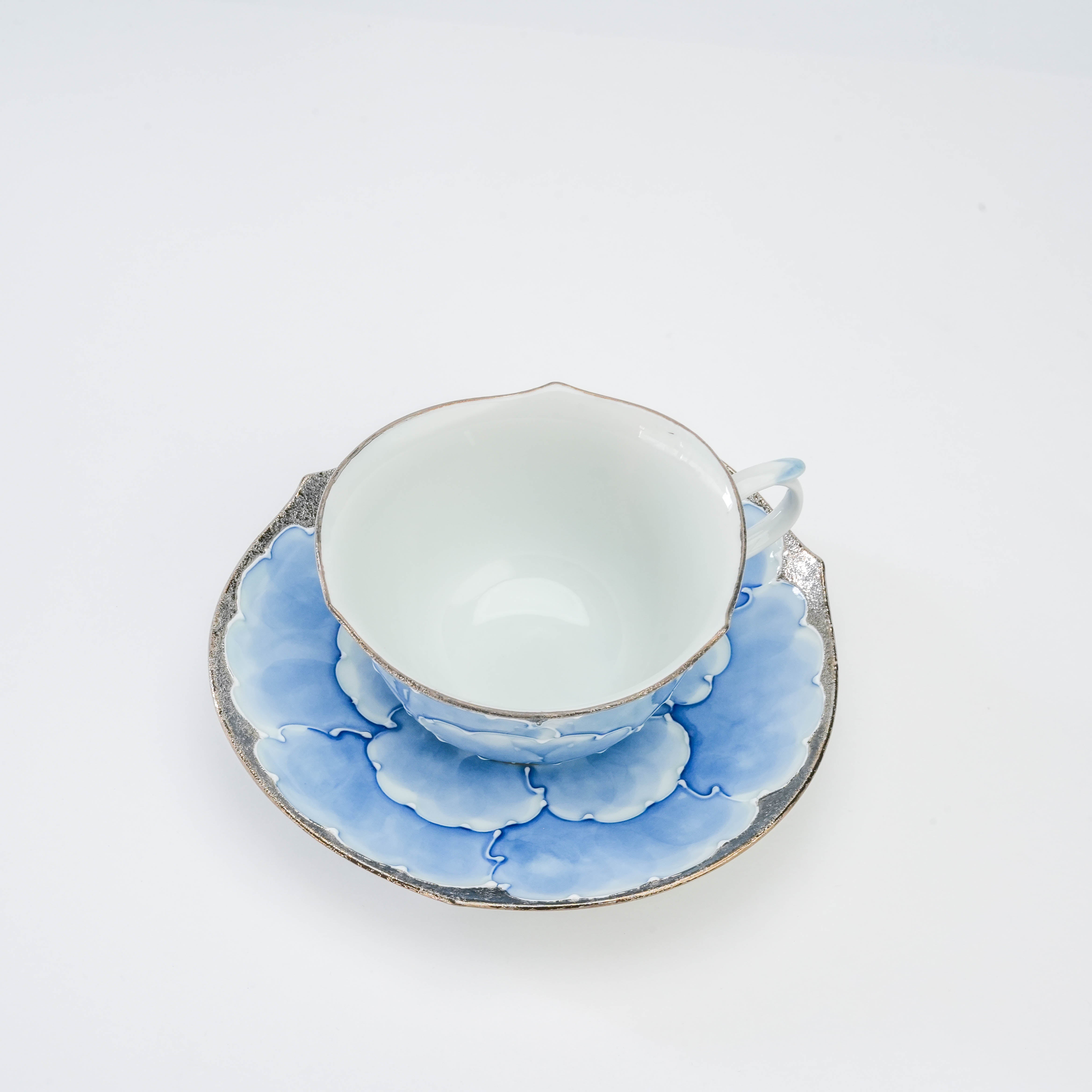 Top view of Bunzan Kiln Arita Peony Cup & Saucer showing intricate hand-painted blue peony petals and fine porcelain craftsmanship.