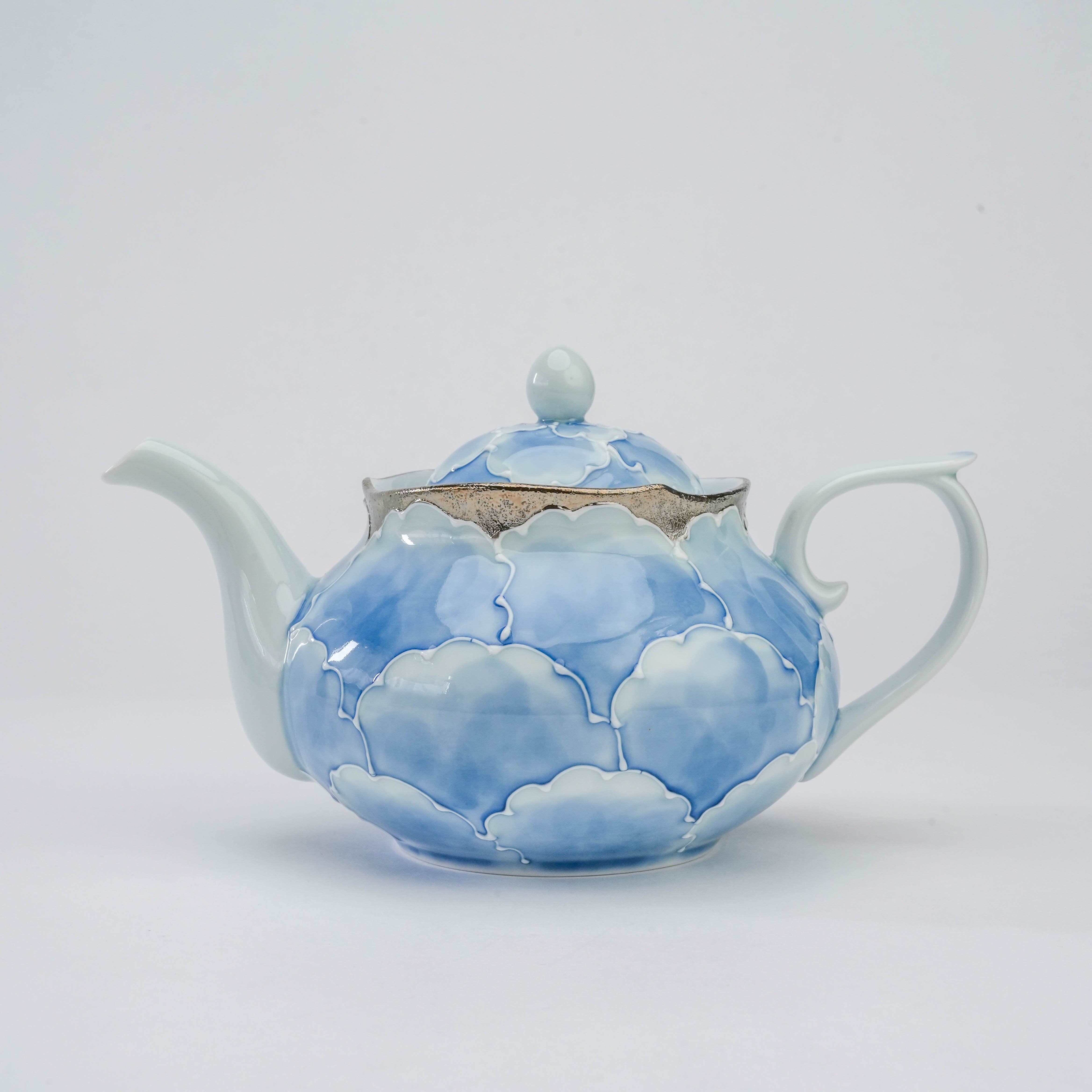 Side profile of the Bunzan Arita Peony Teapot - Platinum Series, showcasing its elegant silhouette and floral blue design.