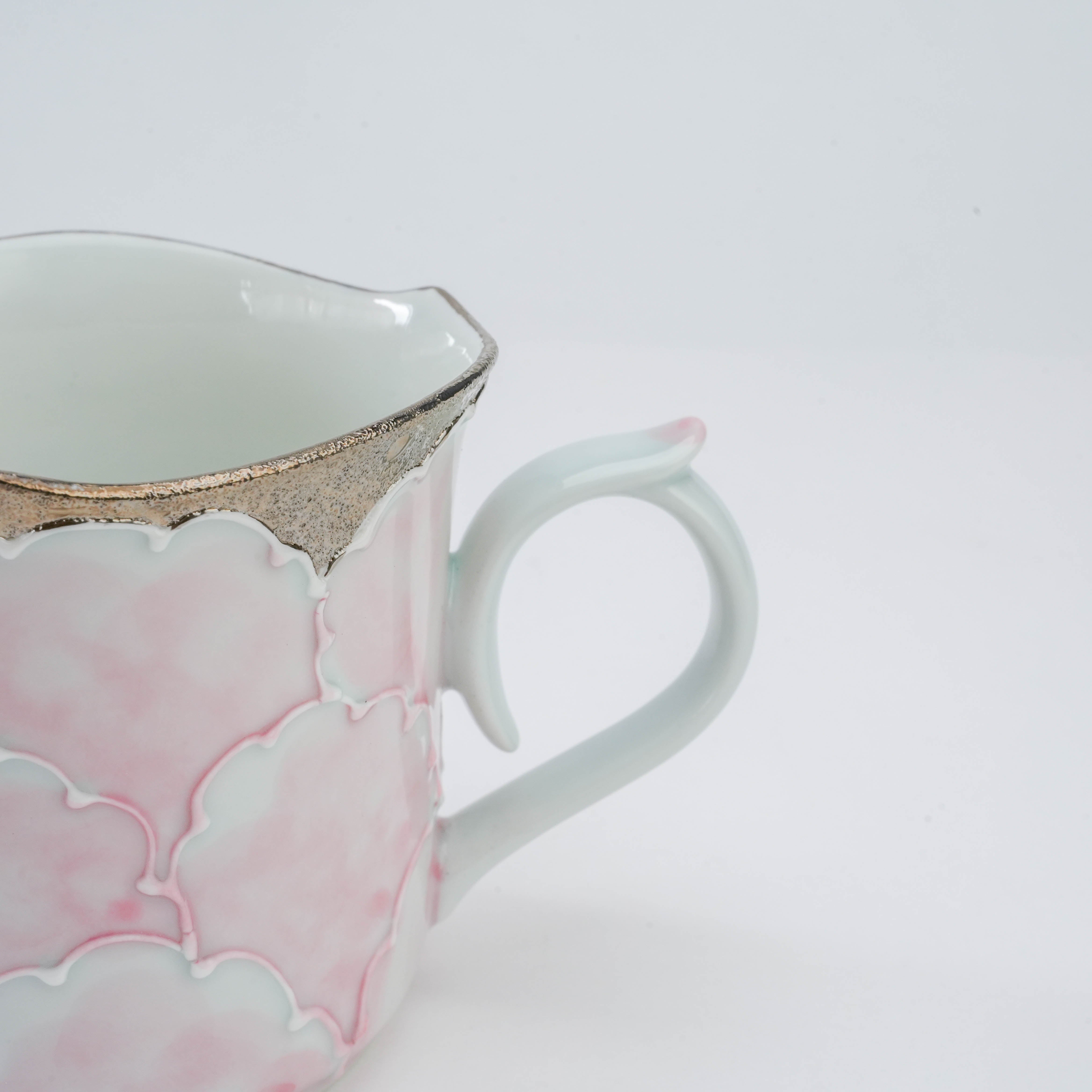 Close-up of Arita Peony Mug handle with pink accent and silver-trimmed rim, showcasing Bunzan Kiln's fine porcelain craftsmanship.