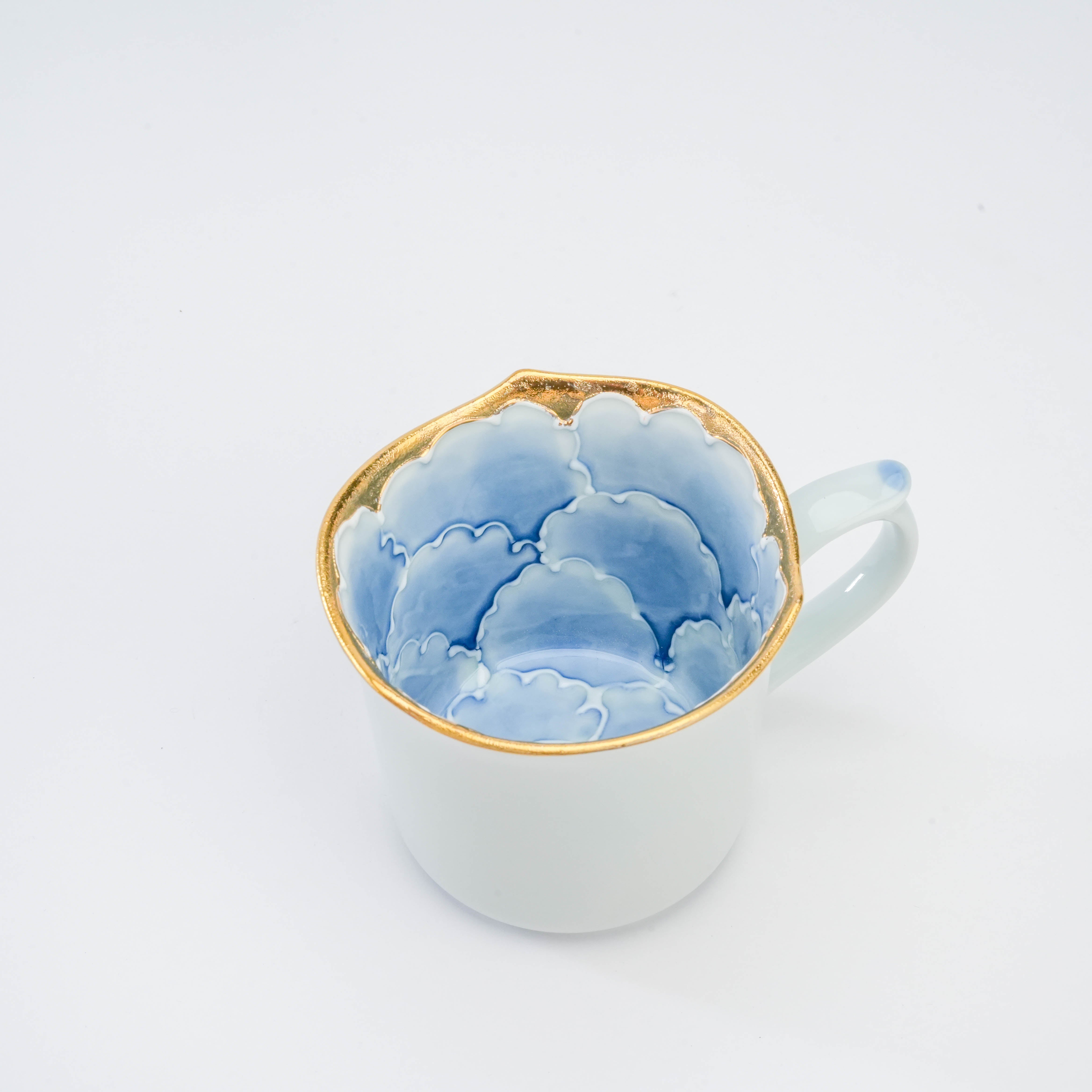 Interior view of Arita Peony Mug featuring hand-painted blue peony petals and luxurious gold detailing, perfect for upscale drinkware collections.