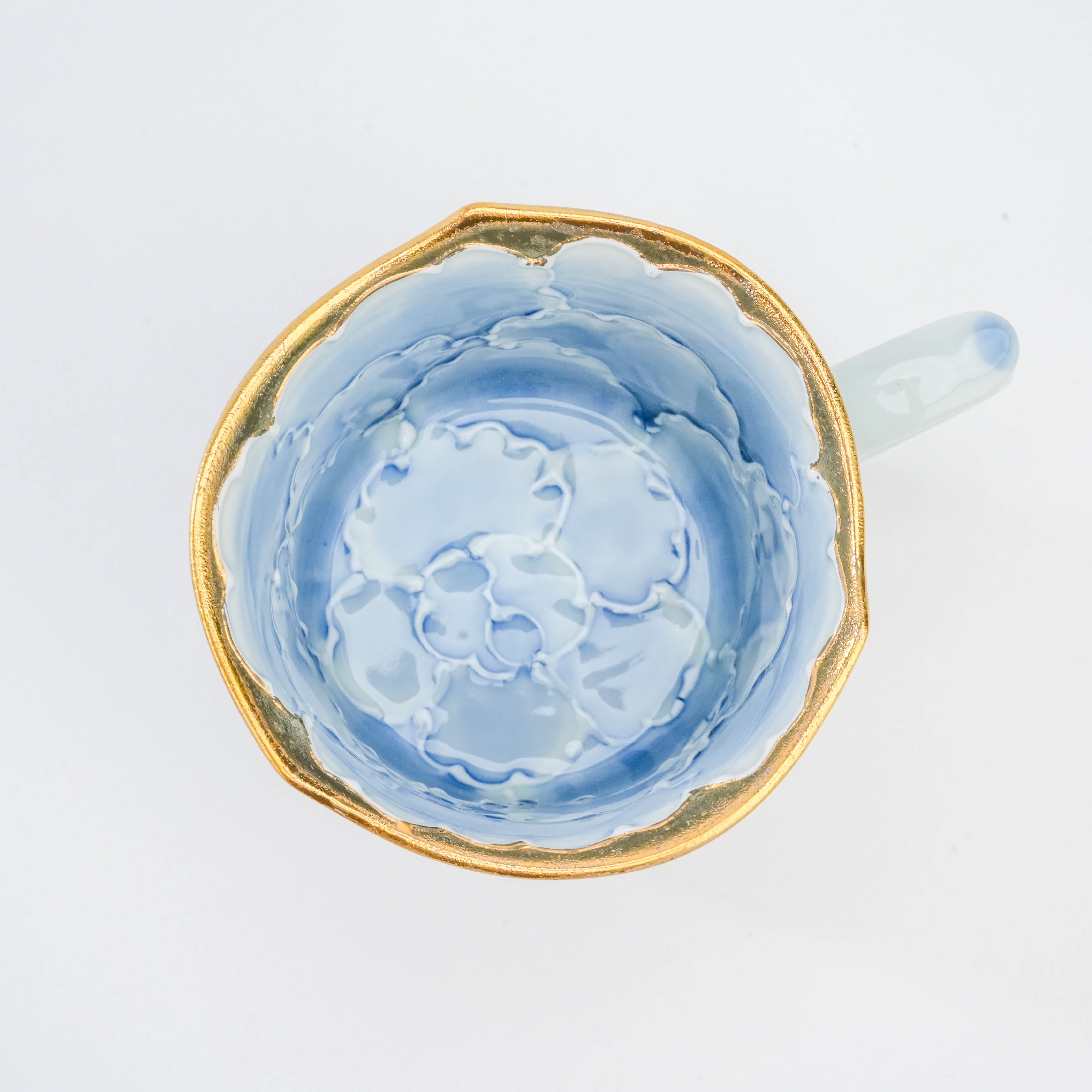 Top view of Arita Peony Mug showing detailed blue peony design and gold-lined edge, a luxurious addition to fine kitchen and dining settings.