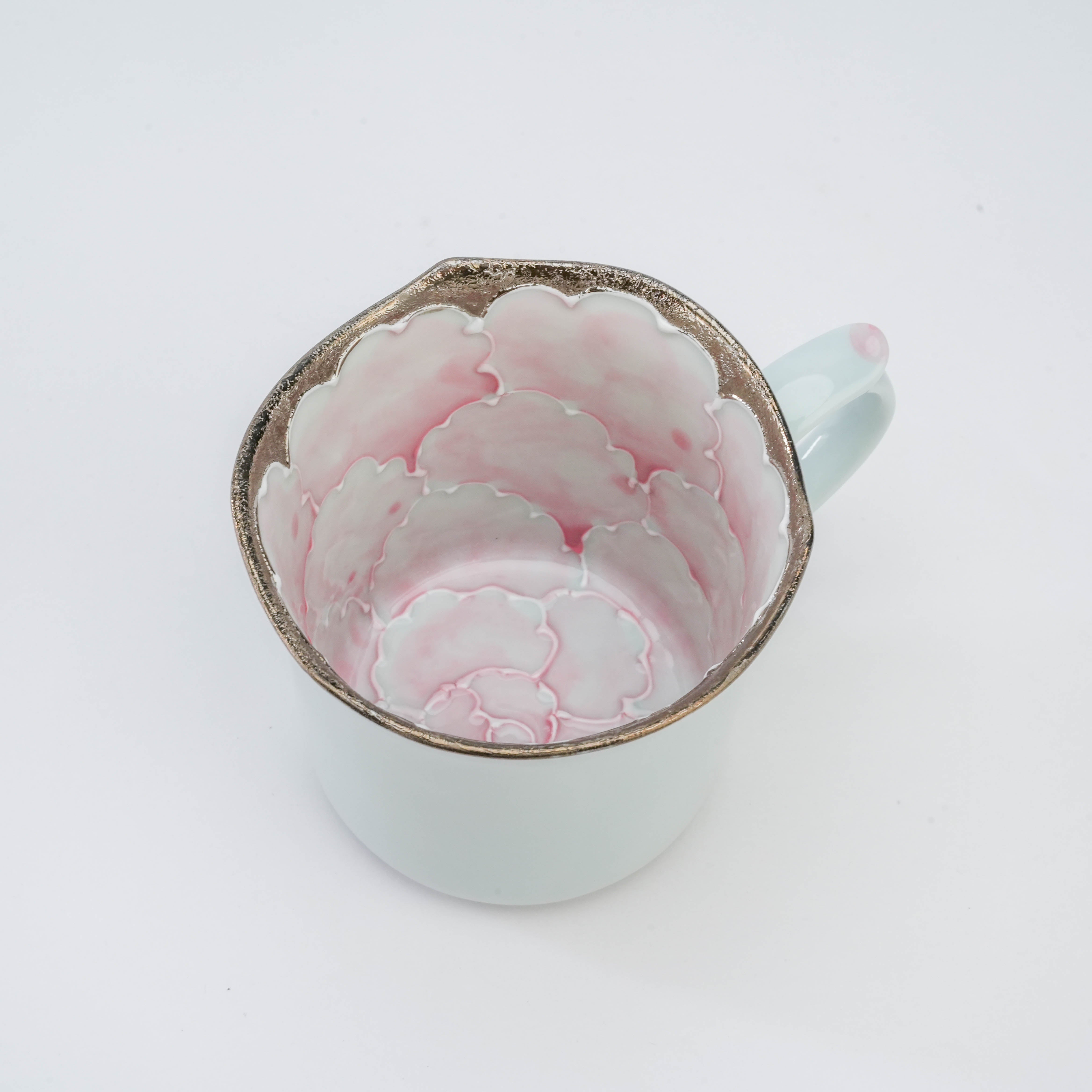Top view of Arita Peony Mug by Bunzan Kiln showing intricate pink peony petals and silver detailing inside the porcelain drinkware.