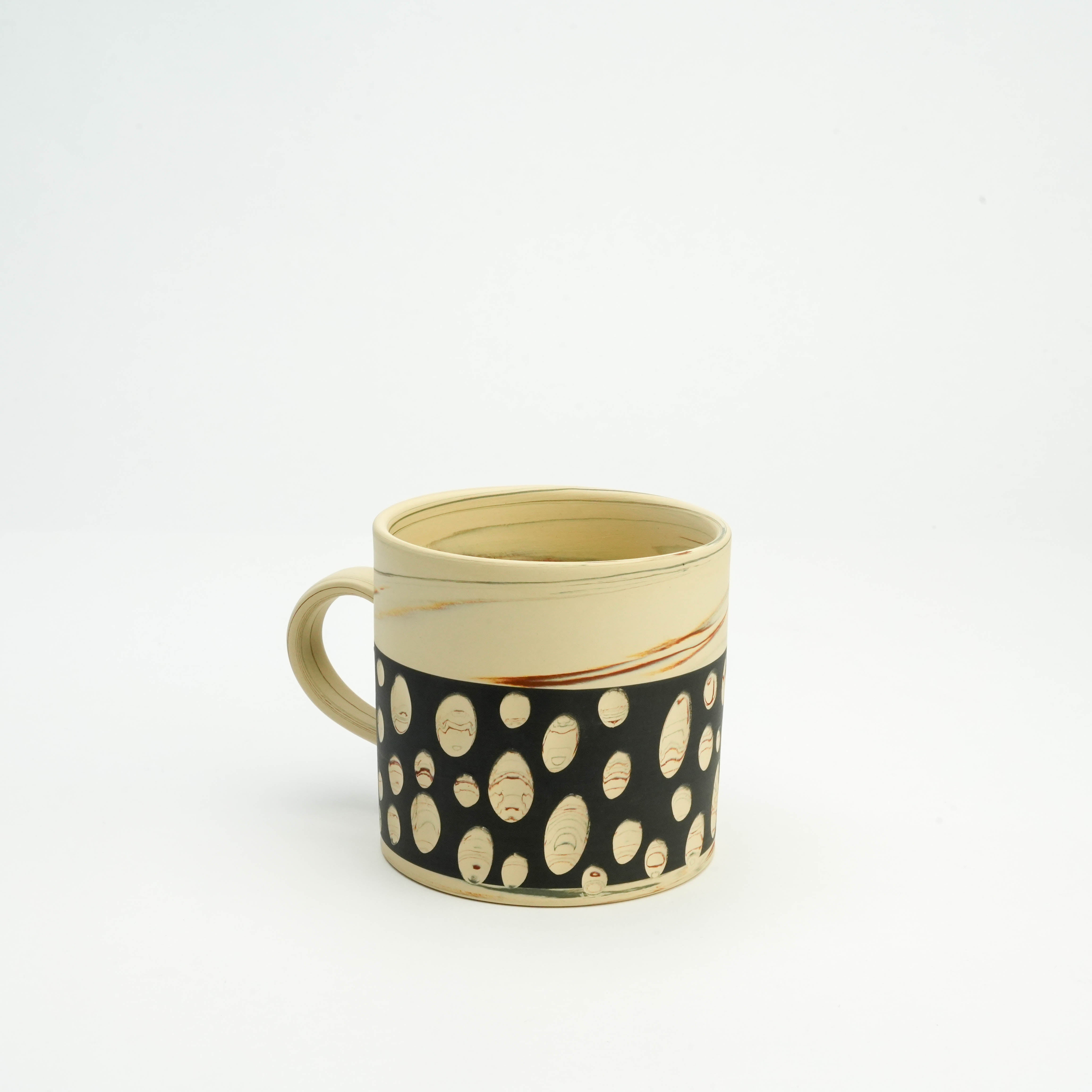 Handcrafted Tokoname Ware Black Polka Dot Mug with unique oval dot pattern and smooth beige ceramic finish. Perfect for daily drinkware use.