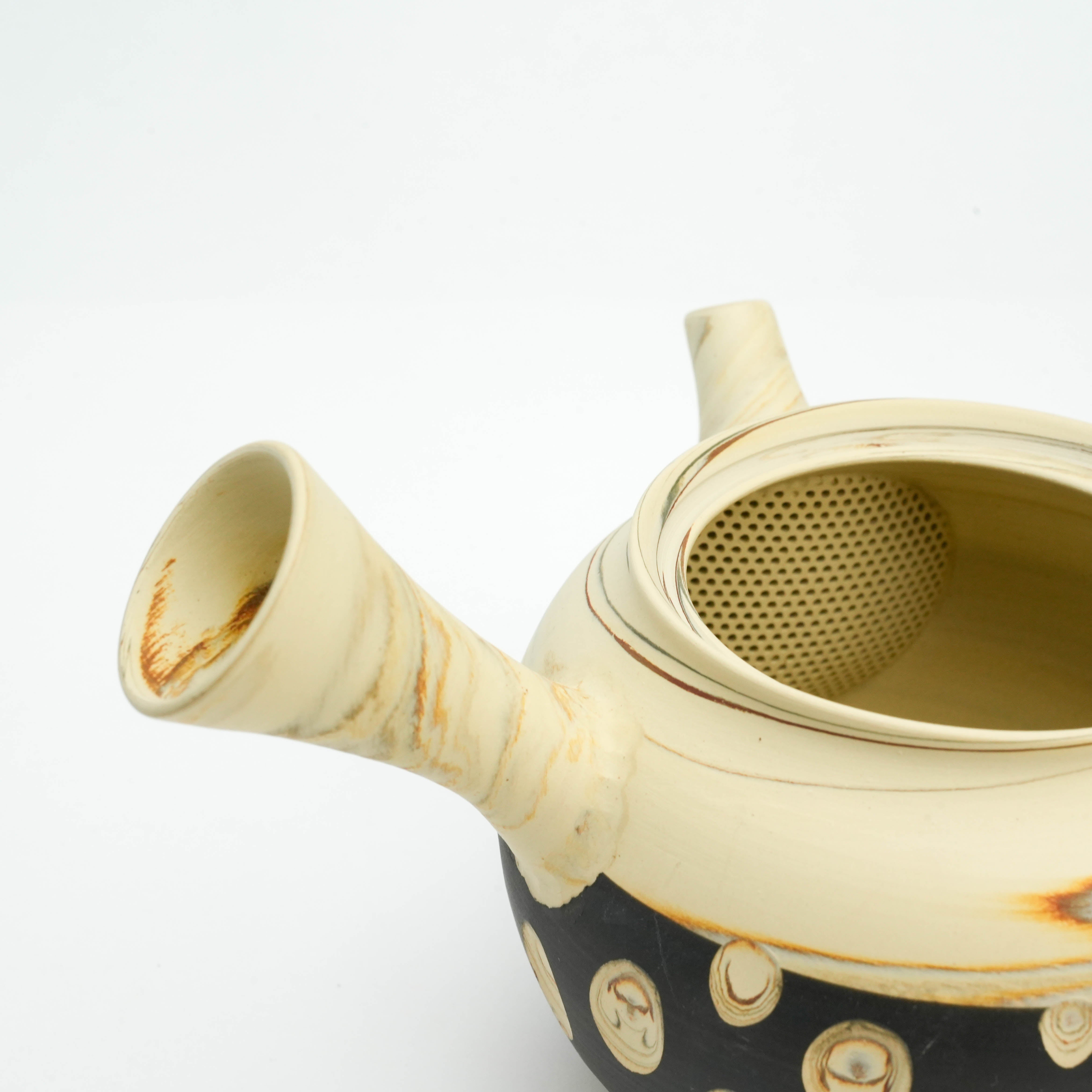 Angled view of Tokoname Teapot opening and spout, emphasizing the handcrafted ceramic mesh strainer and marbled clay texture.