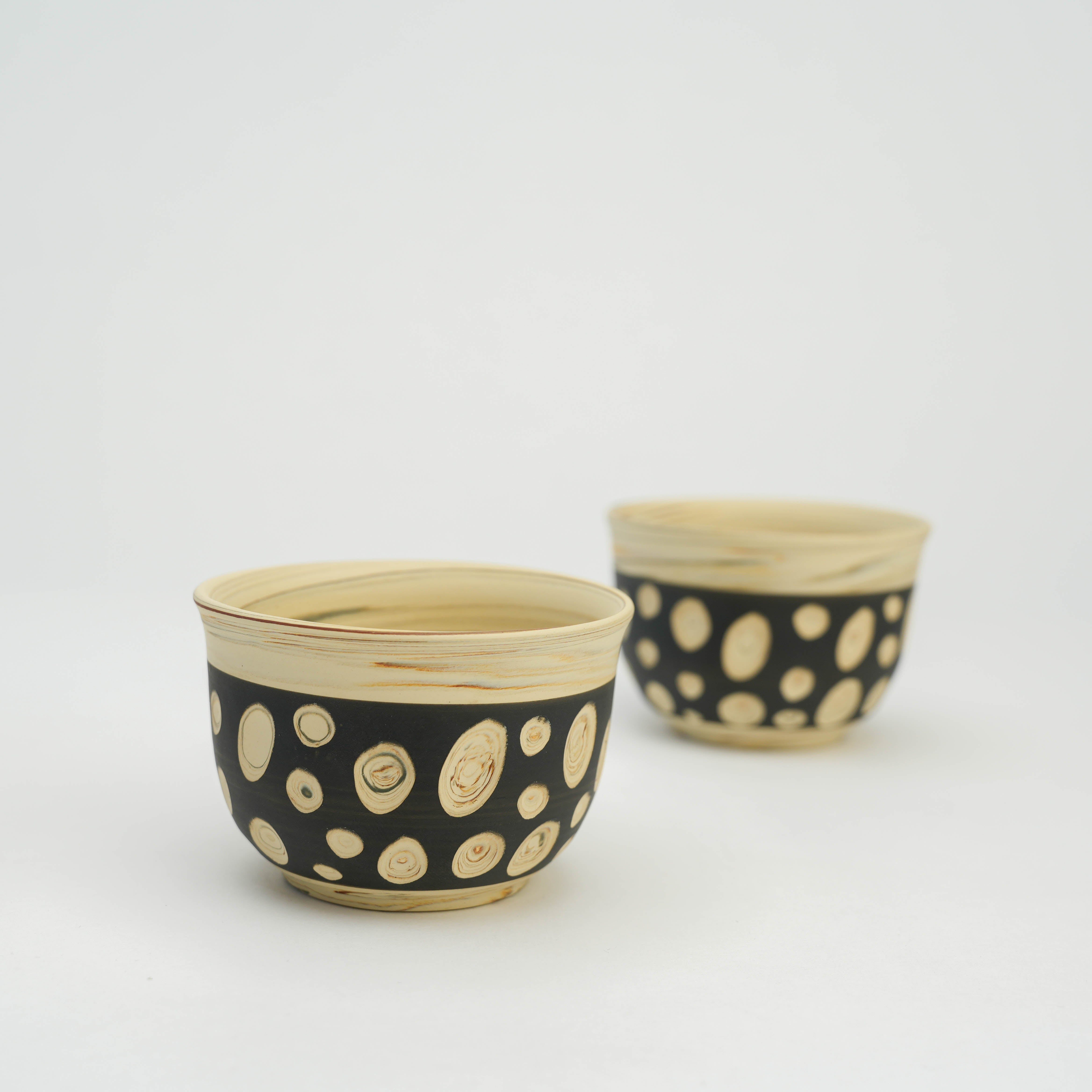 Two Tokoname Polka Dot Teacups with black and beige nerikomi pattern, part of the Japanese tea set by Kenji Touen.