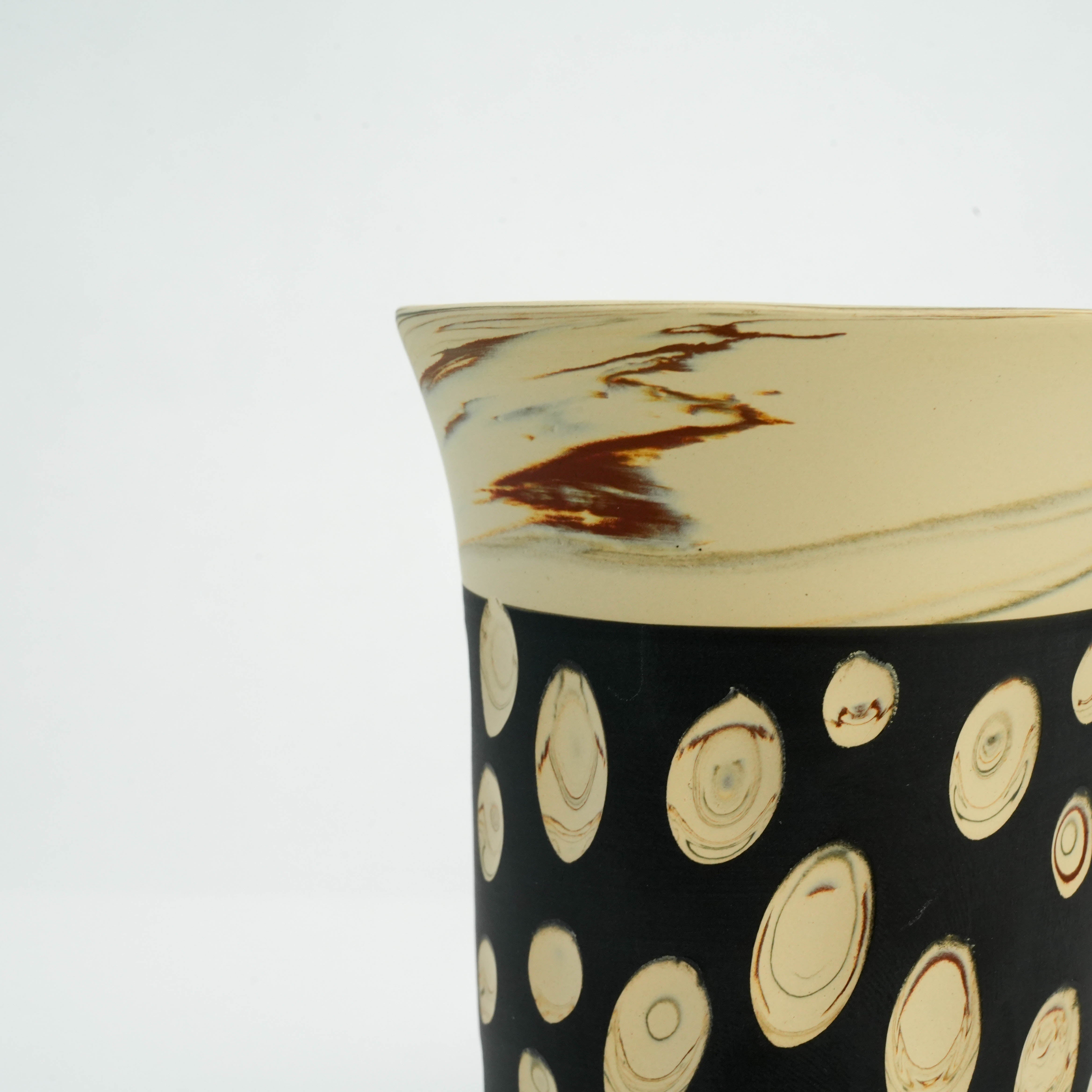 Detail view of handcrafted Tokoname tumbler rim and polka dot design, showcasing traditional Japanese ceramic artistry.