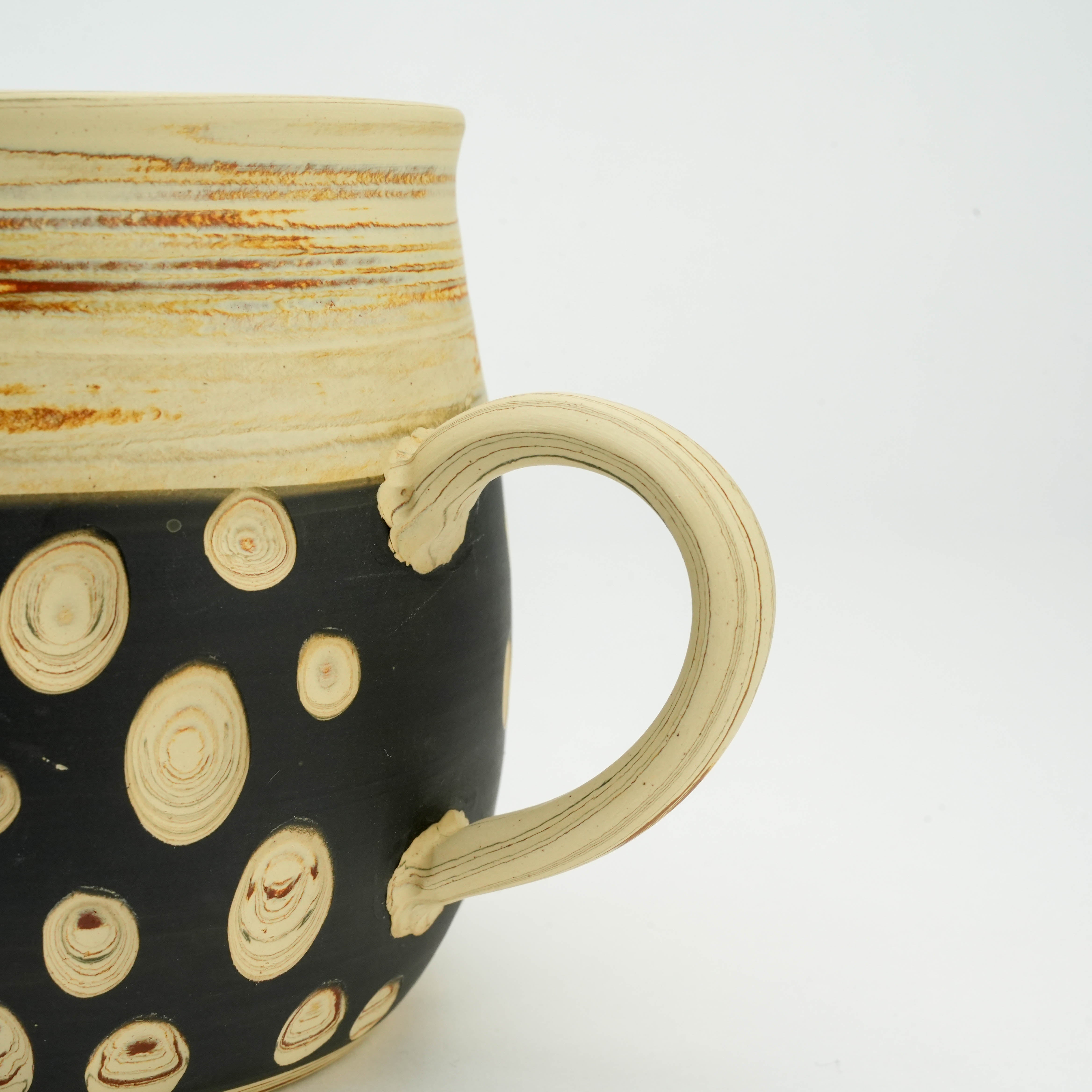 Detailed view of Tokoname Mug handle showing handcrafted cream ceramic with subtle ridges, part of Kenji Touen's artisan drinkware collection.