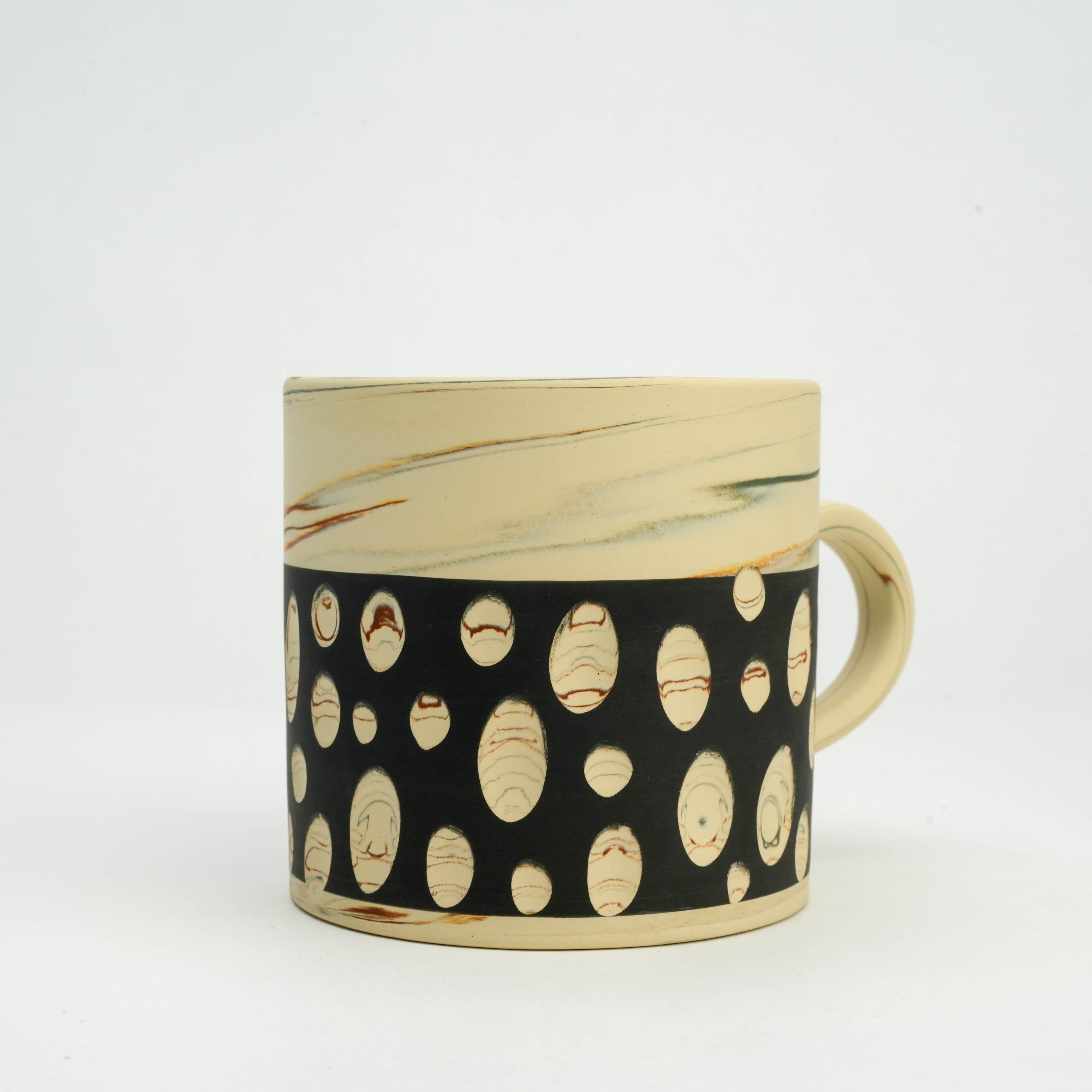 Front view of Tokoname Ware Polka Dot Mug - Black, highlighting handcrafted polka dot pattern and natural clay textures for elegant tableware.