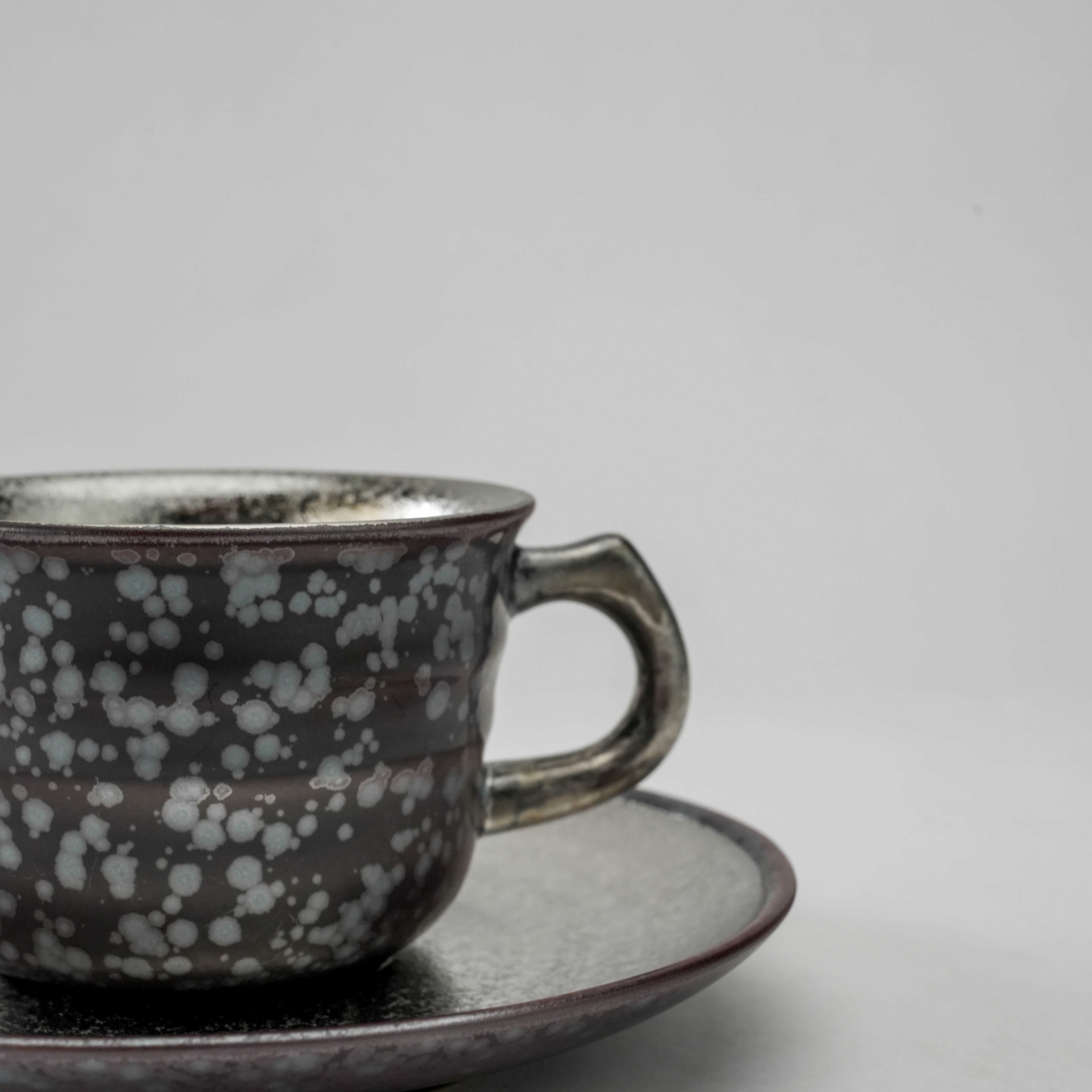 Close-up of Arita Ware Silver Coffee Cup handle and glaze details, highlighting unique craftsmanship and shimmering crystal glaze finish.