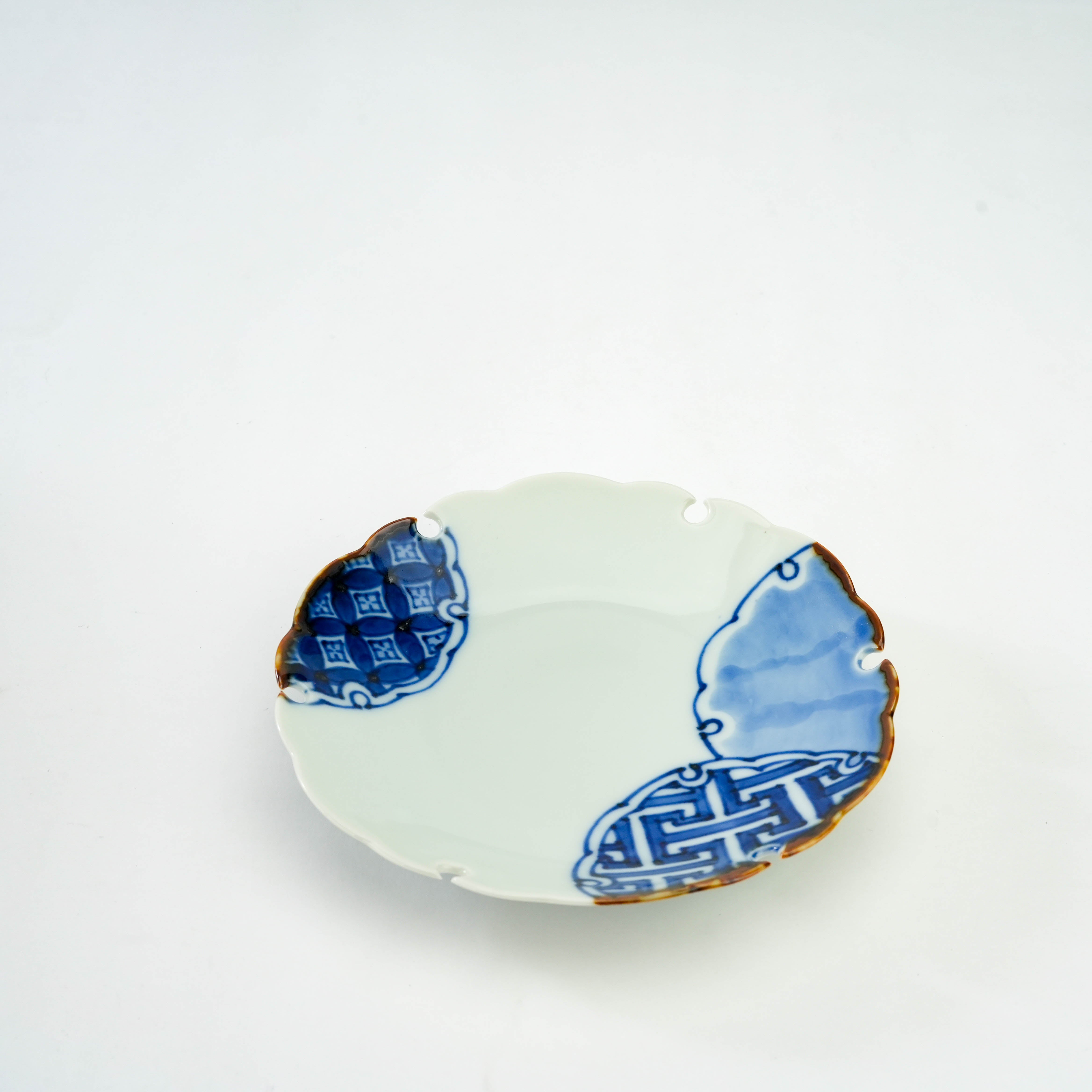 Hand-painted Arita Ware Snow Circle Plate featuring intricate blue ground patterns and a snow-inspired scalloped rim, perfect for serving or decor.