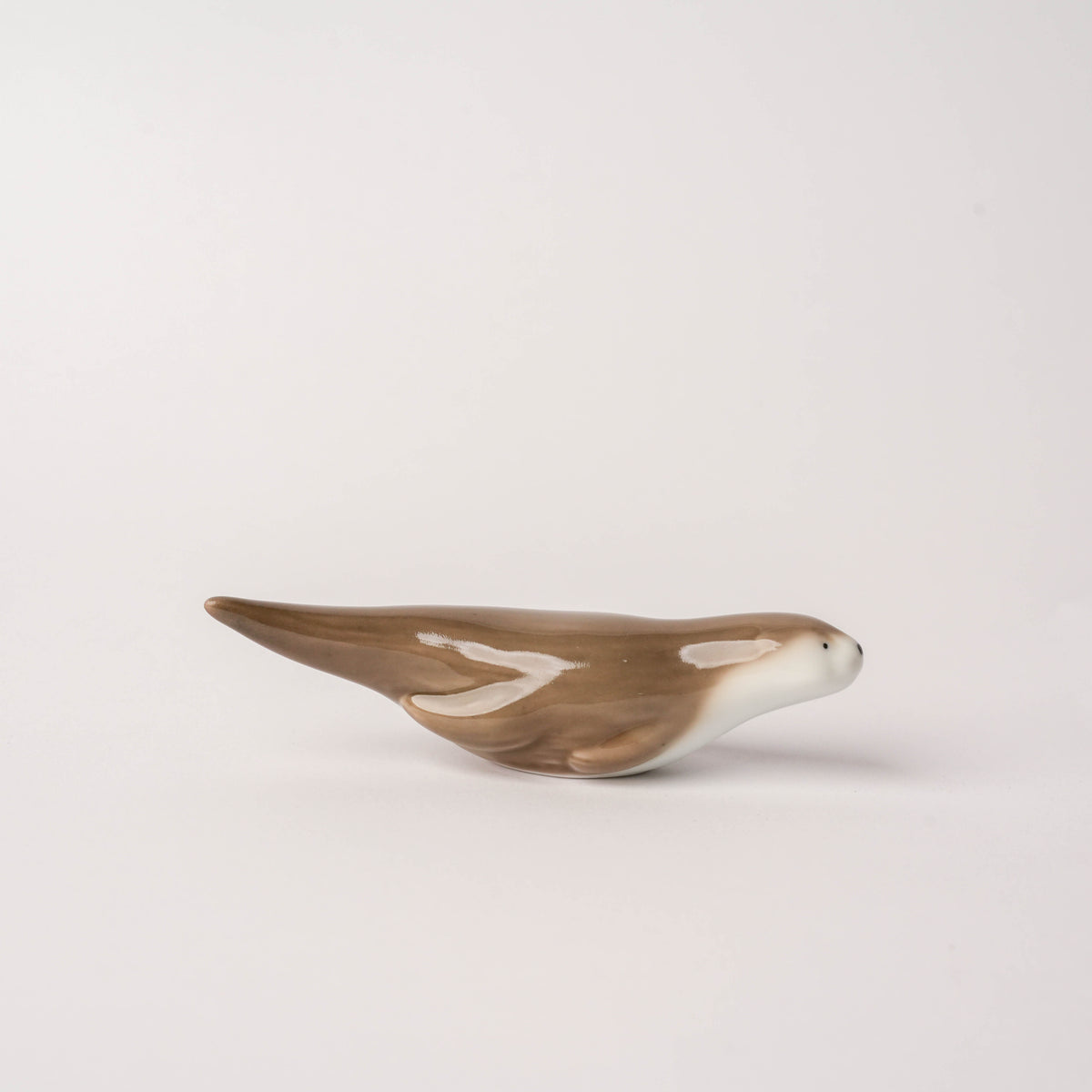 Bottom angle of the hand-painted porcelain otter chopstick rest displaying its sturdy base and craftsmanship from Arita, Japan.