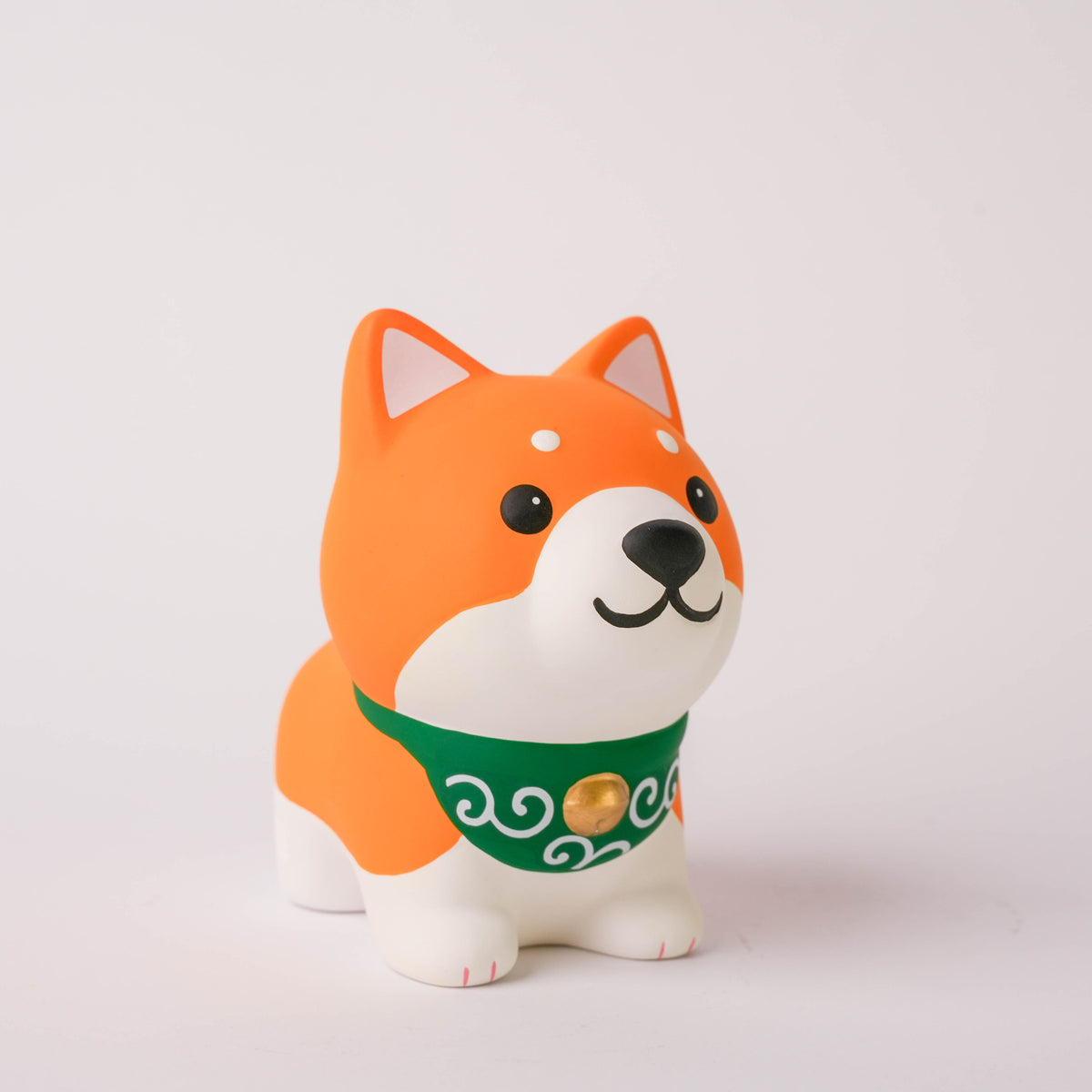 Cheerful ceramic Shiba Dog ornament with orange fur, white face, black eyes, and a green scarf, 10 cm tall, decorative figurine for home decor.