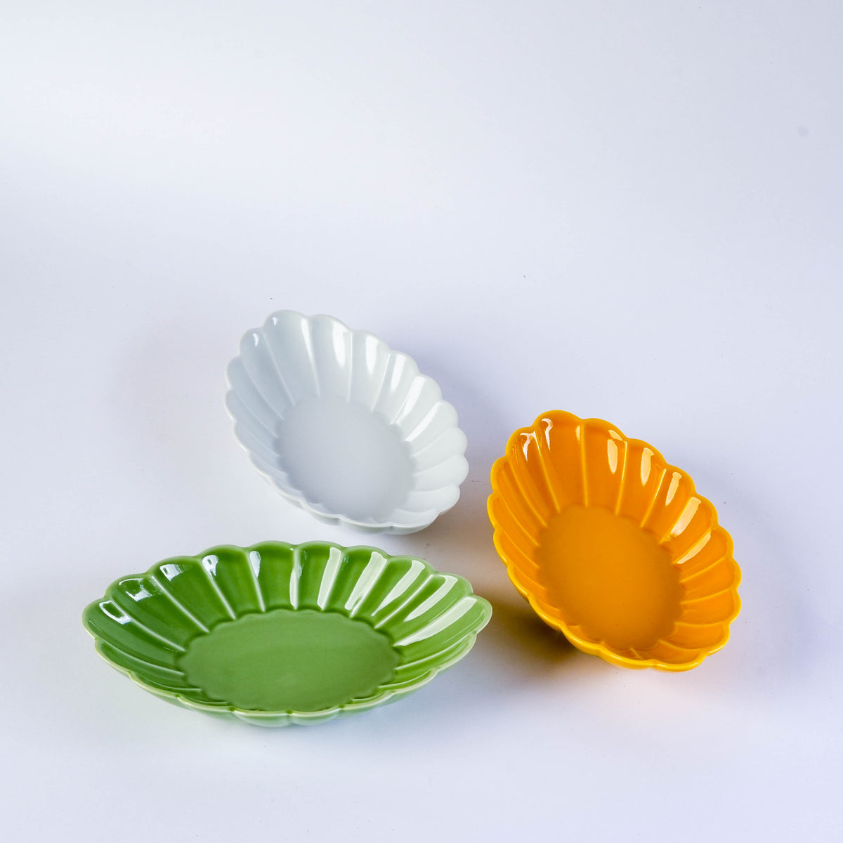 White ceramic oval plate with carved chrysanthemum design, versatile dinnerware for serving appetizers or desserts