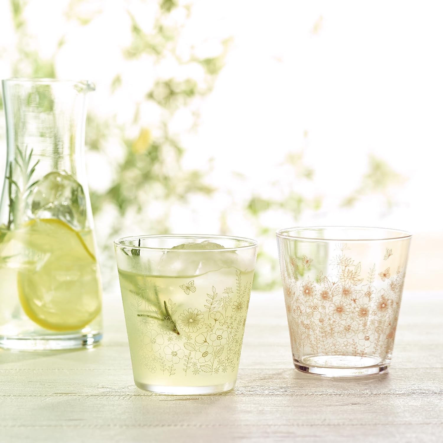 Toyo-Sasaki Garden Time Tumbler Set used for serving drinks outdoors, showcasing elegant floral glassware in natural light.