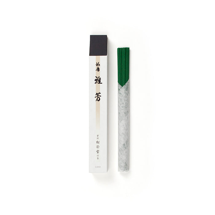 Shoyeido Premium Incense - Gaho with green incense sticks wrapped in paper next to refined packaging. Infused with agarwood, cinnamon, and spices.