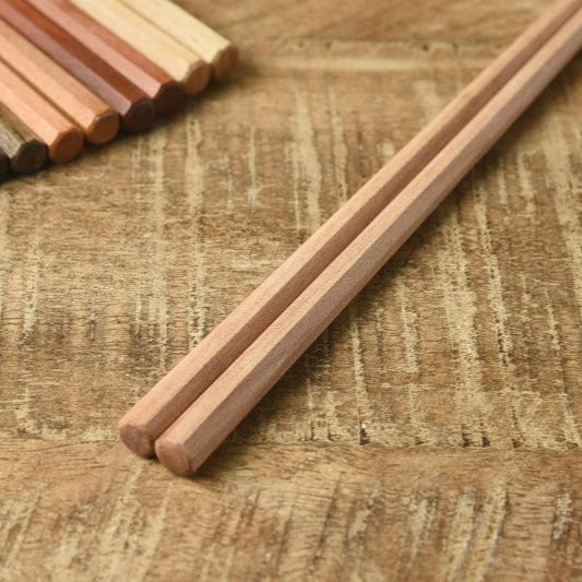Close-up of Kawai Tetoca prune wood chopsticks with octagonal tops and square tips, highlighting smooth texture and handcrafted quality.