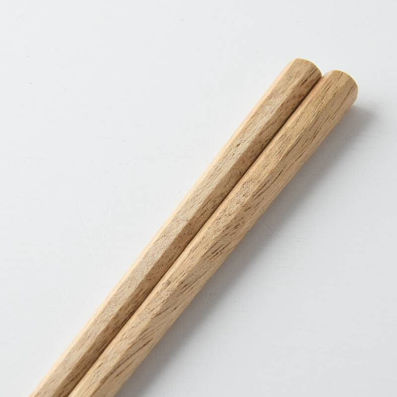 Close-up of Kawai Tetoca Olive Chopsticks showcasing smooth olive wood texture and ergonomic octagonal grip.
