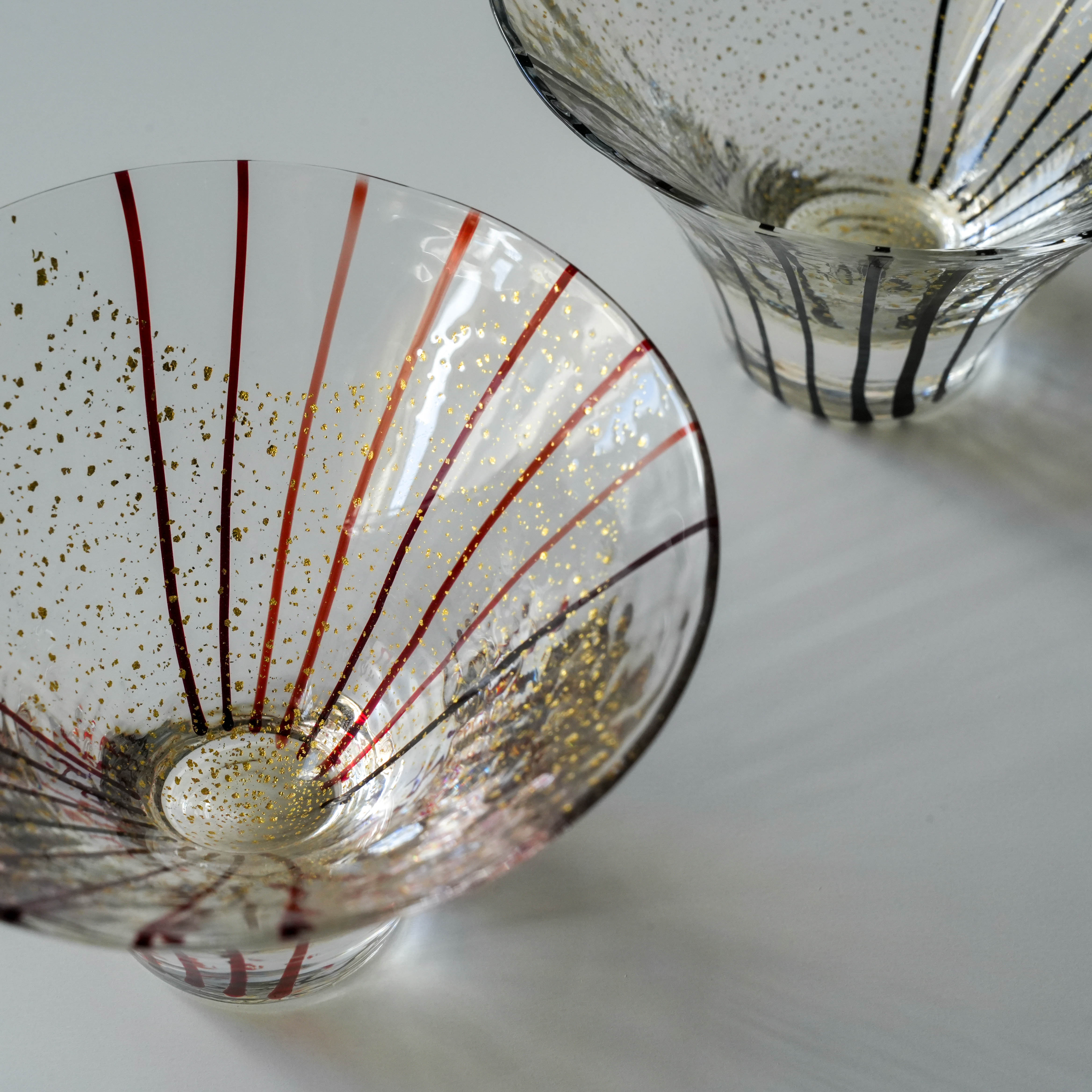 Detailed view of Toyo-Sasaki Cup Set with gold specks and red/black stripes. Edo Glass artistry from Japan’s Yachiyo kiln.