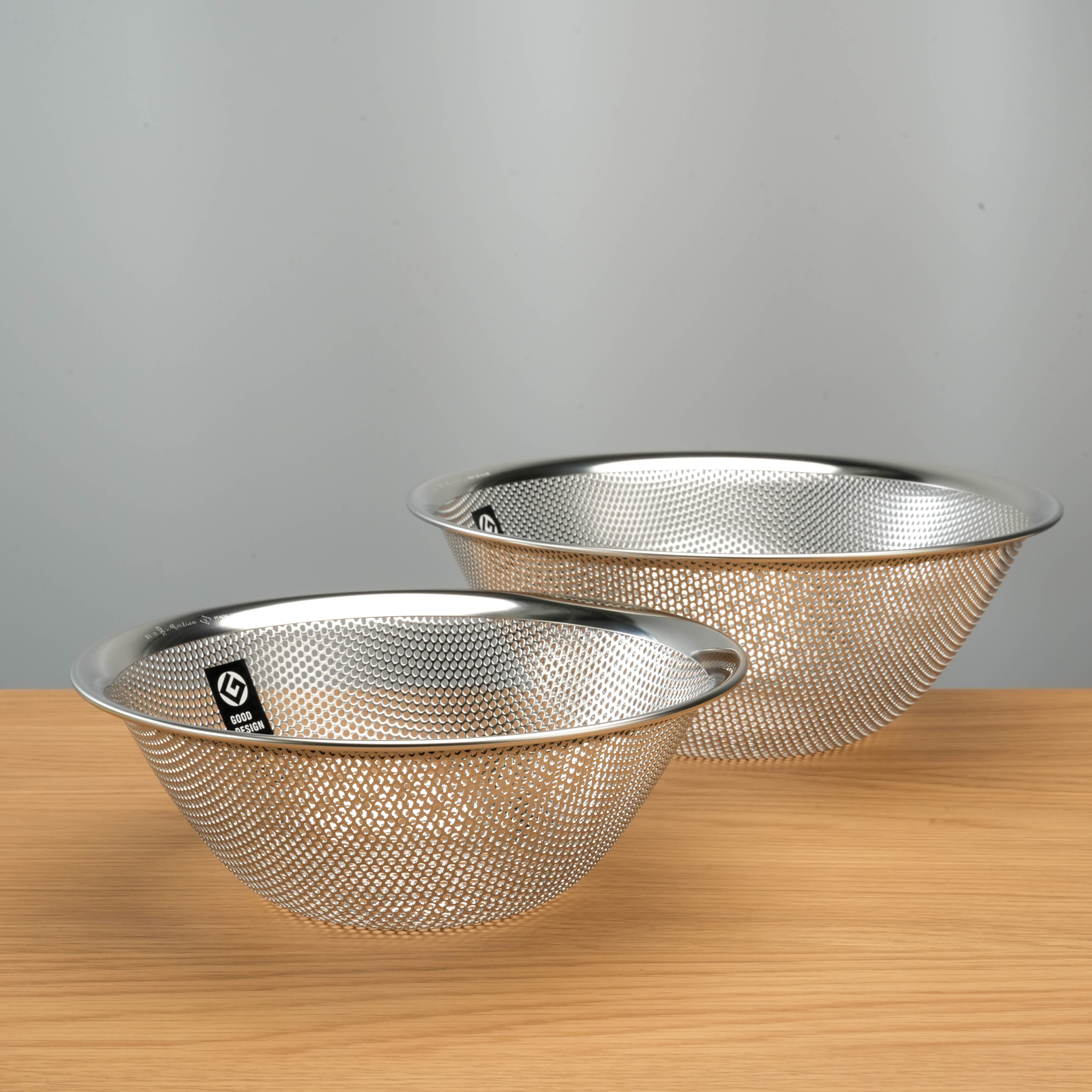 Set of two Sori Yanagi Stainless Steel Perforated Colanders showcasing durable 18-8 stainless steel construction for efficient kitchen prep.