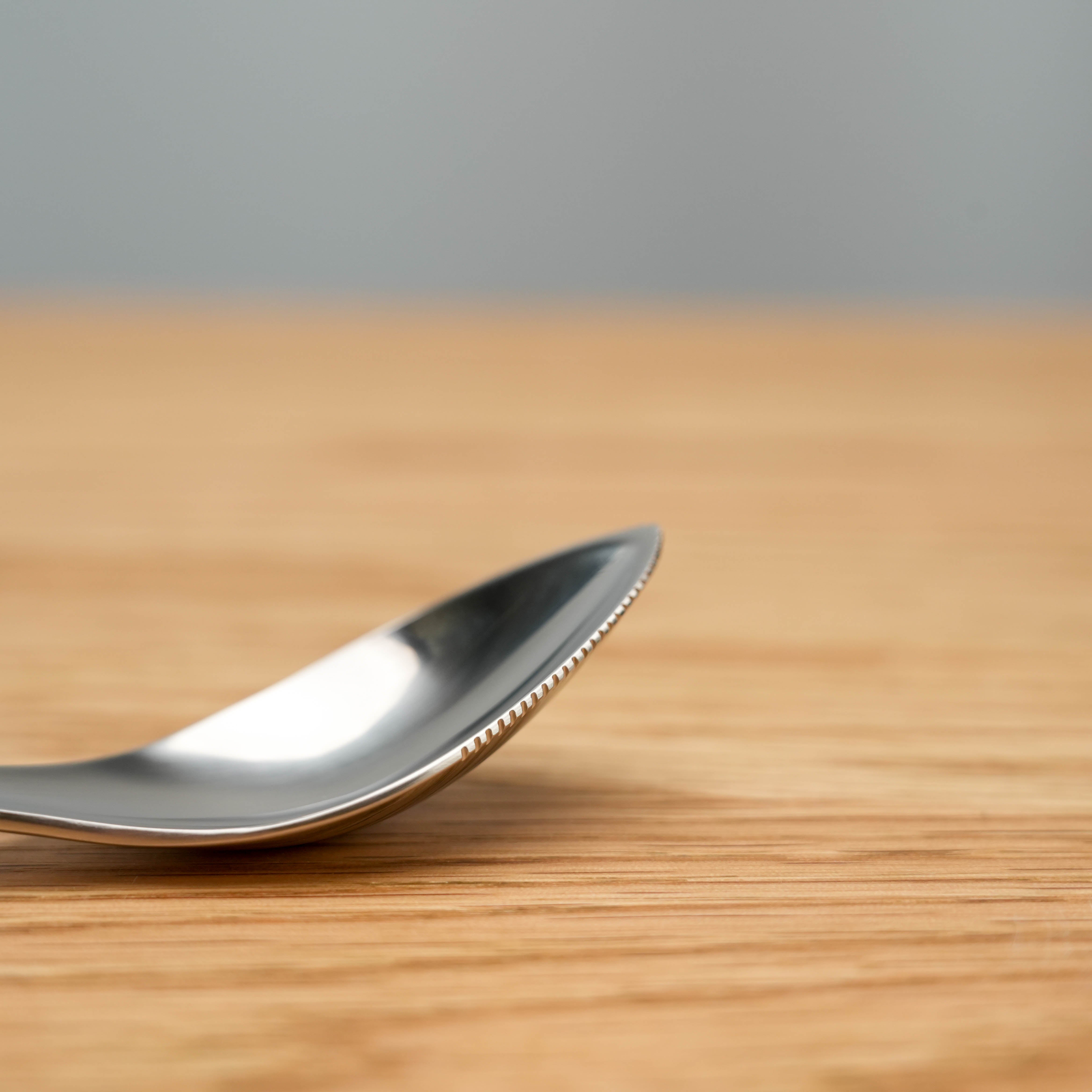 Close-up of Sori Yanagi Stainless Steel Grapefruit Spoon serrated edge, ideal for effortlessly scooping citrus fruit with precision and style.