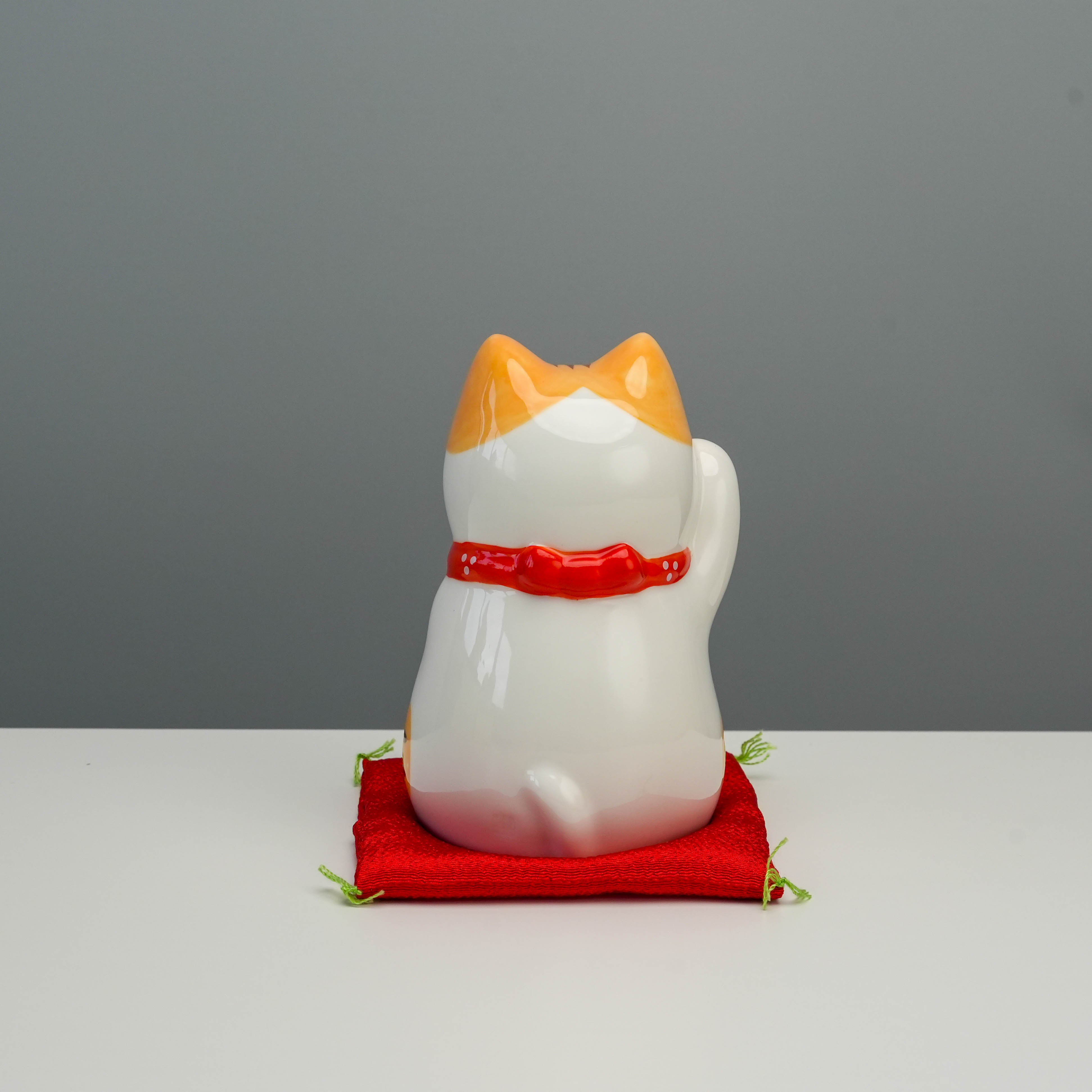 Back view of handcrafted Yakushigama Bliss Beckoning Cat Tiger figurine, highlighting smooth ceramic finish and traditional Japanese design.