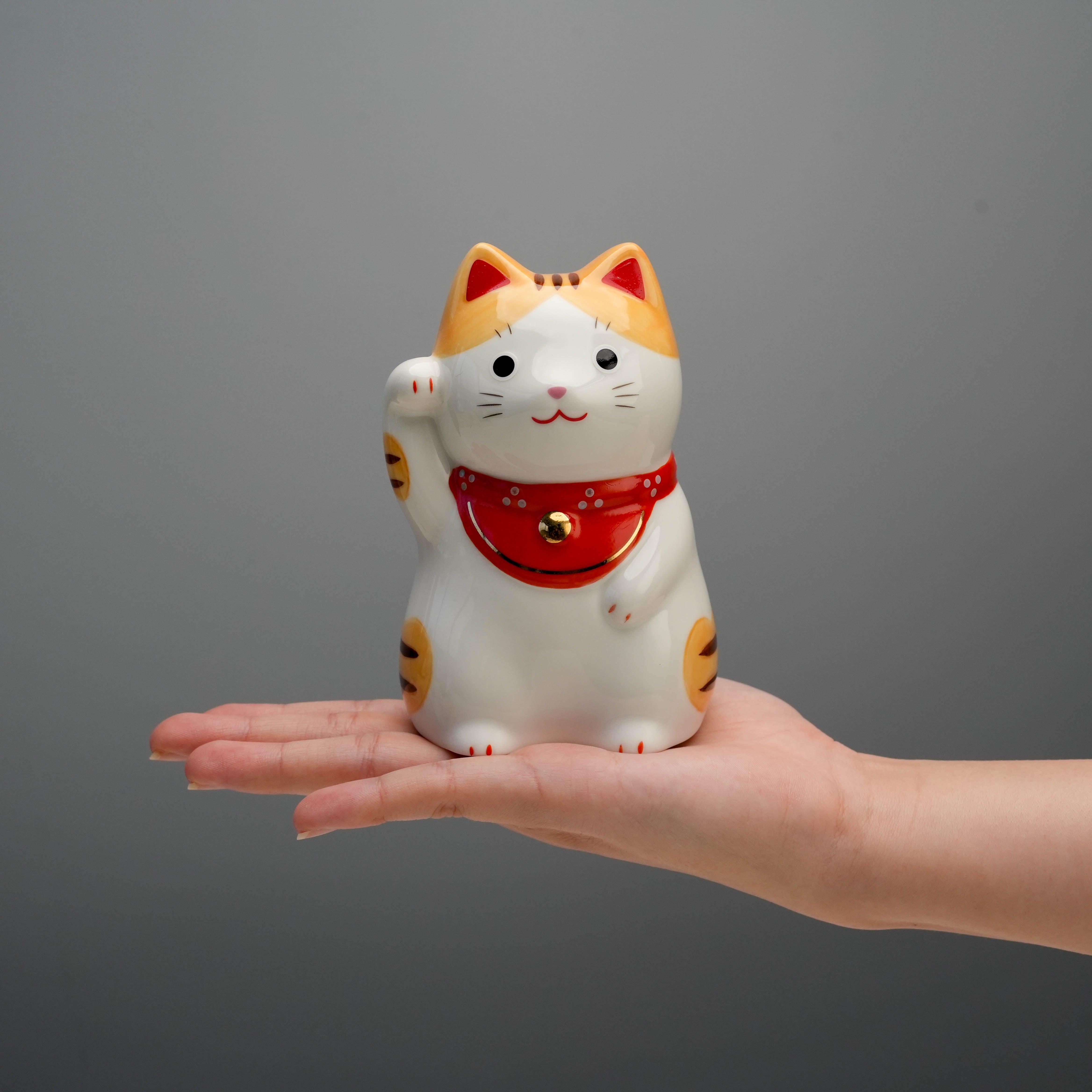 Handheld Yakushigama Bliss Beckoning Cat Tiger figurine showing compact 12cm size, perfect for shelves or altars in home and garden decor.