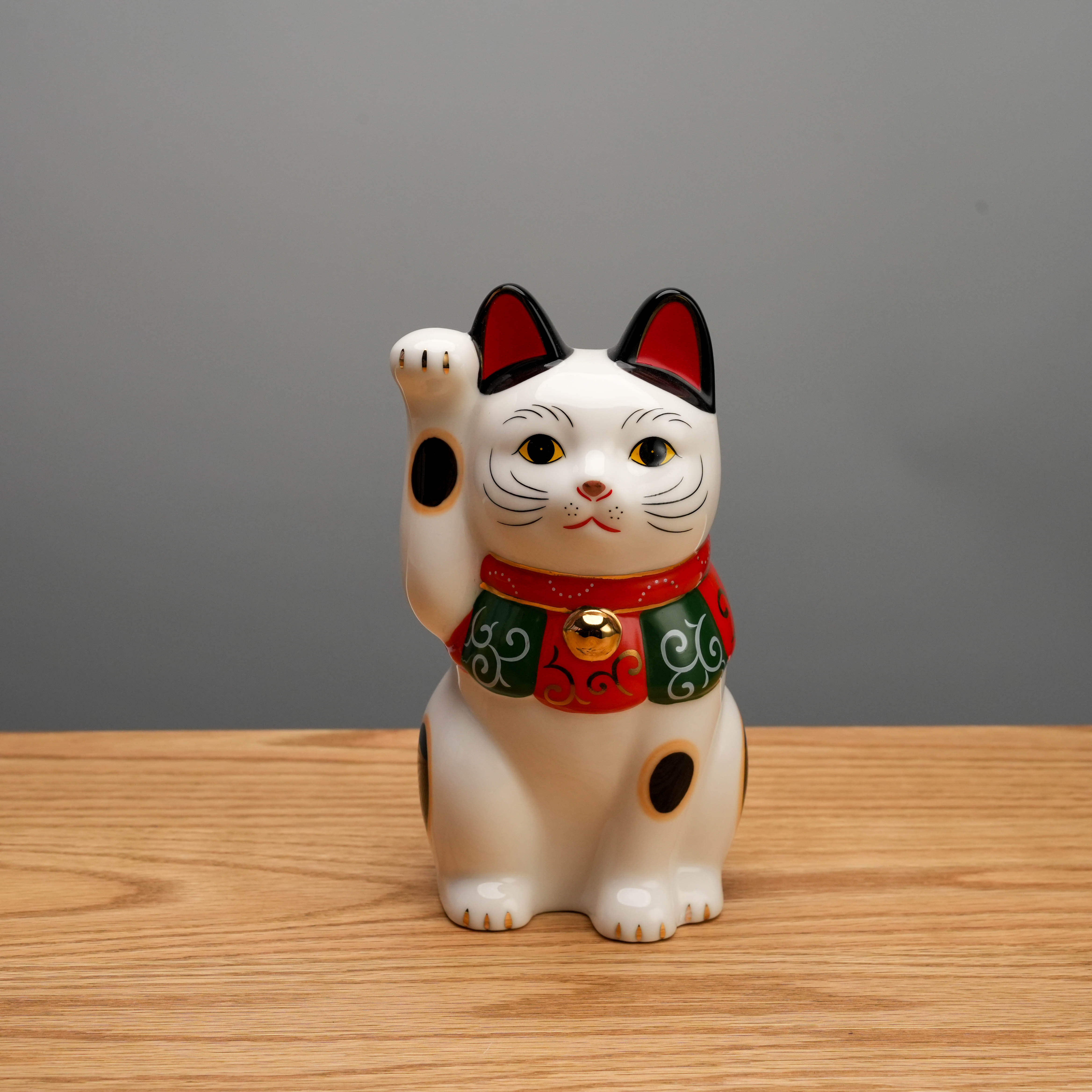 Yakushigama Arabesque Scarf Beckoning Cat figurine with raised paw, symbolizing luck and prosperity, ideal for home decor or gifting.