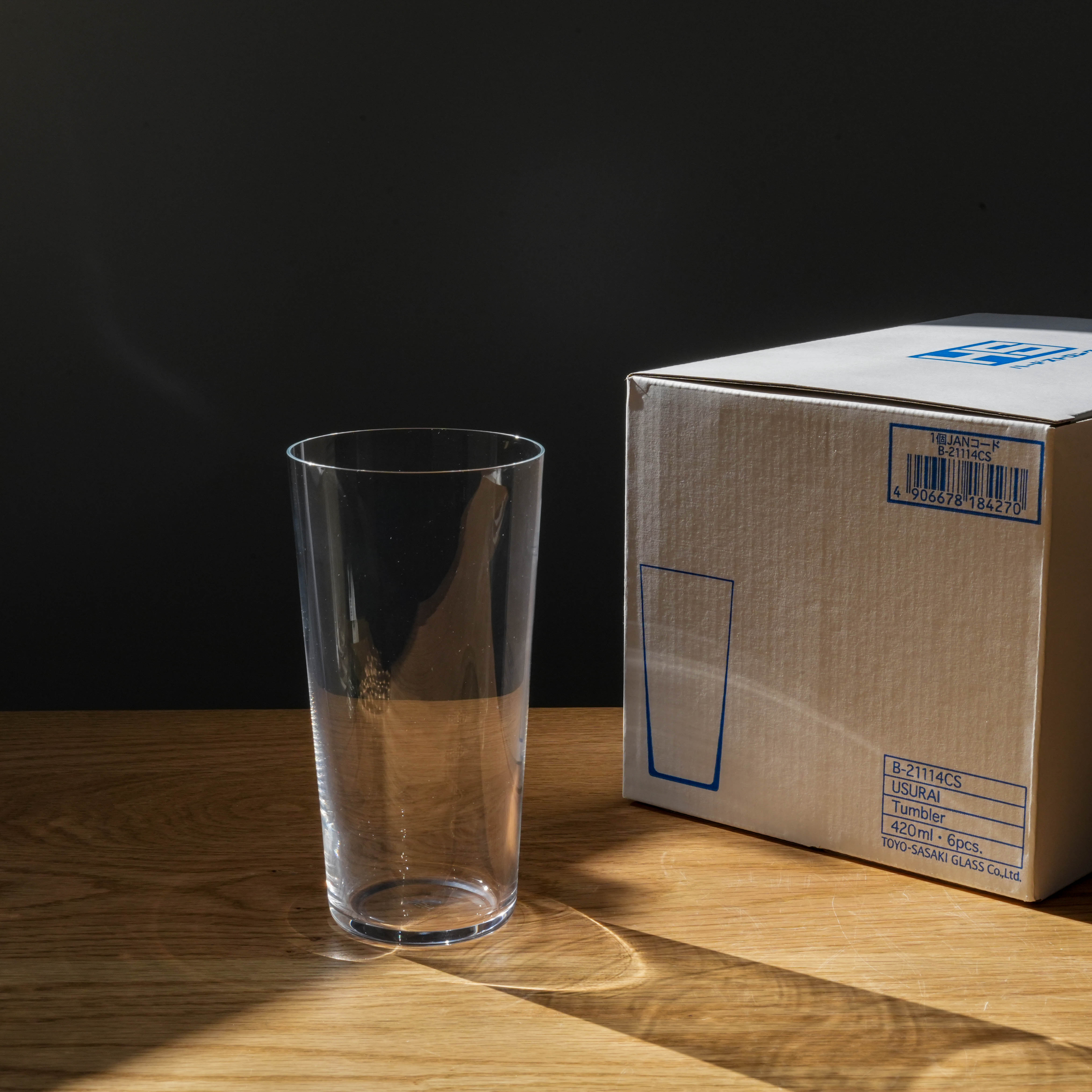 Toyo-Sasaki Tall Glass Set | Durable, Scratch-Resistant, Made in Japan tumbler placed beside original packaging box on wooden table.