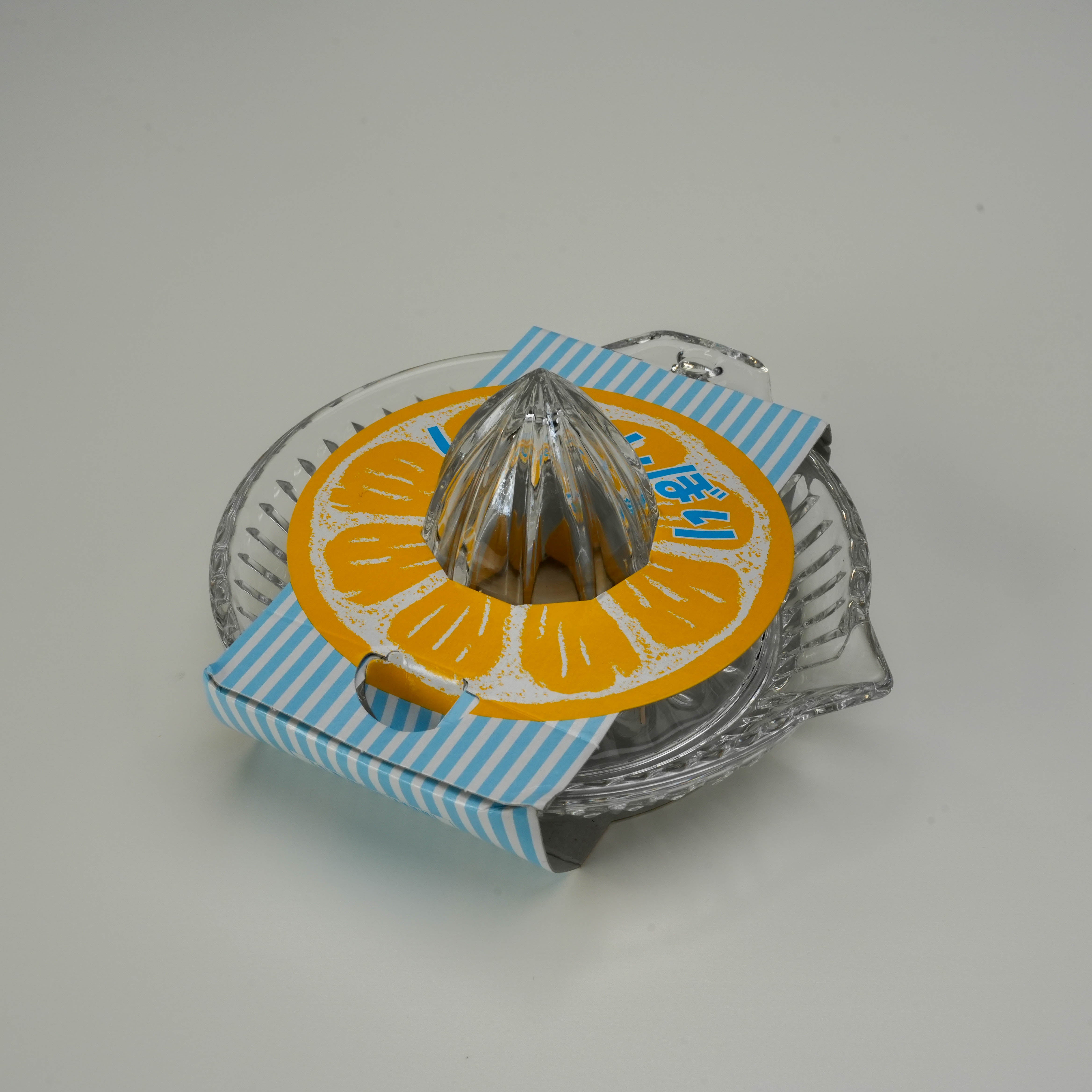 Toyo-Sasaki Lemon Squeezer - Round Glass Extractor with ridged center and wide bowl, ideal for easy citrus juicing in any kitchen setting.
