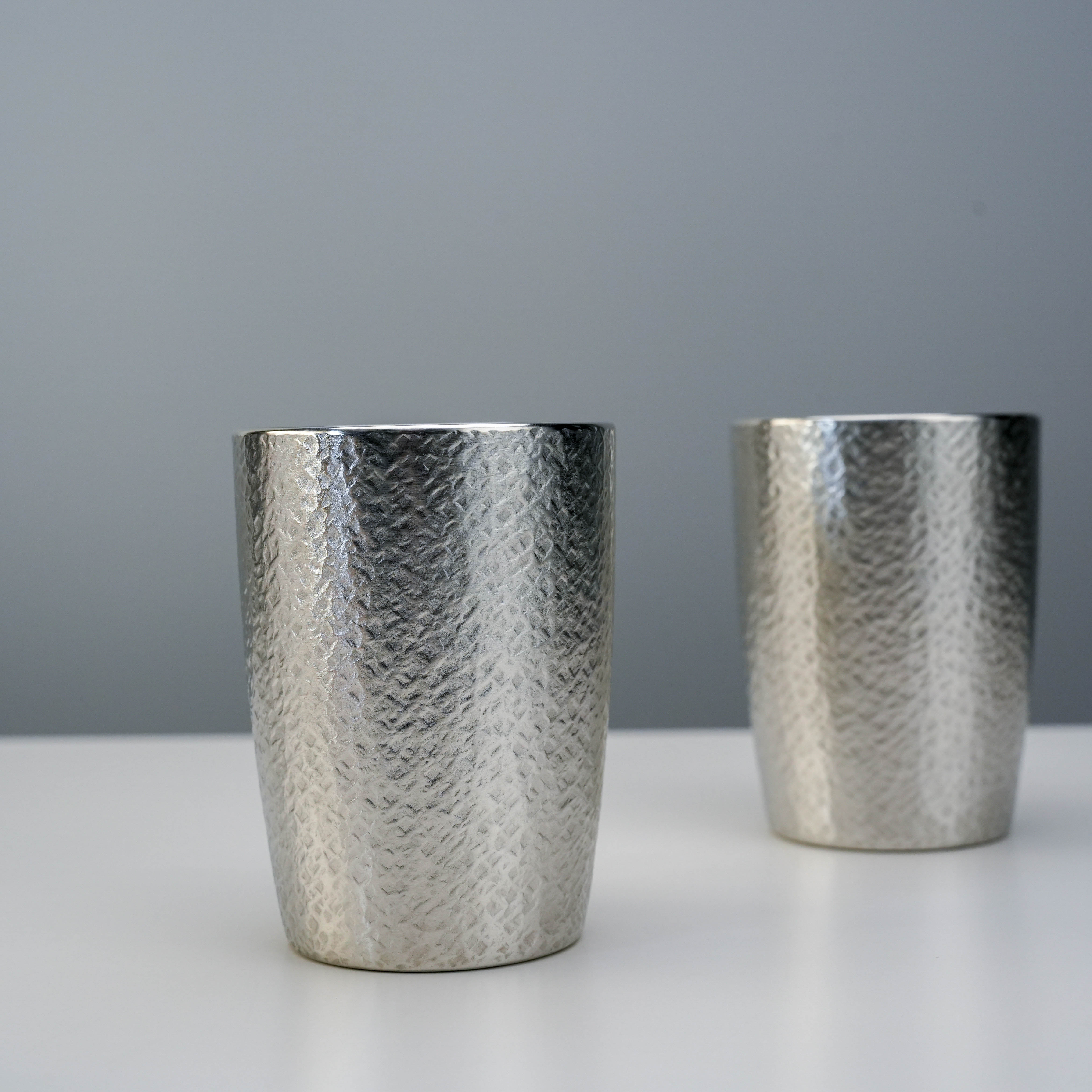 Osaka Tinware Tumbler Set - Tin Tumbler | Pure Tin, 2pc features two hammered pure tin tumblers with a reflective finish, ideal for elegant drinkware.